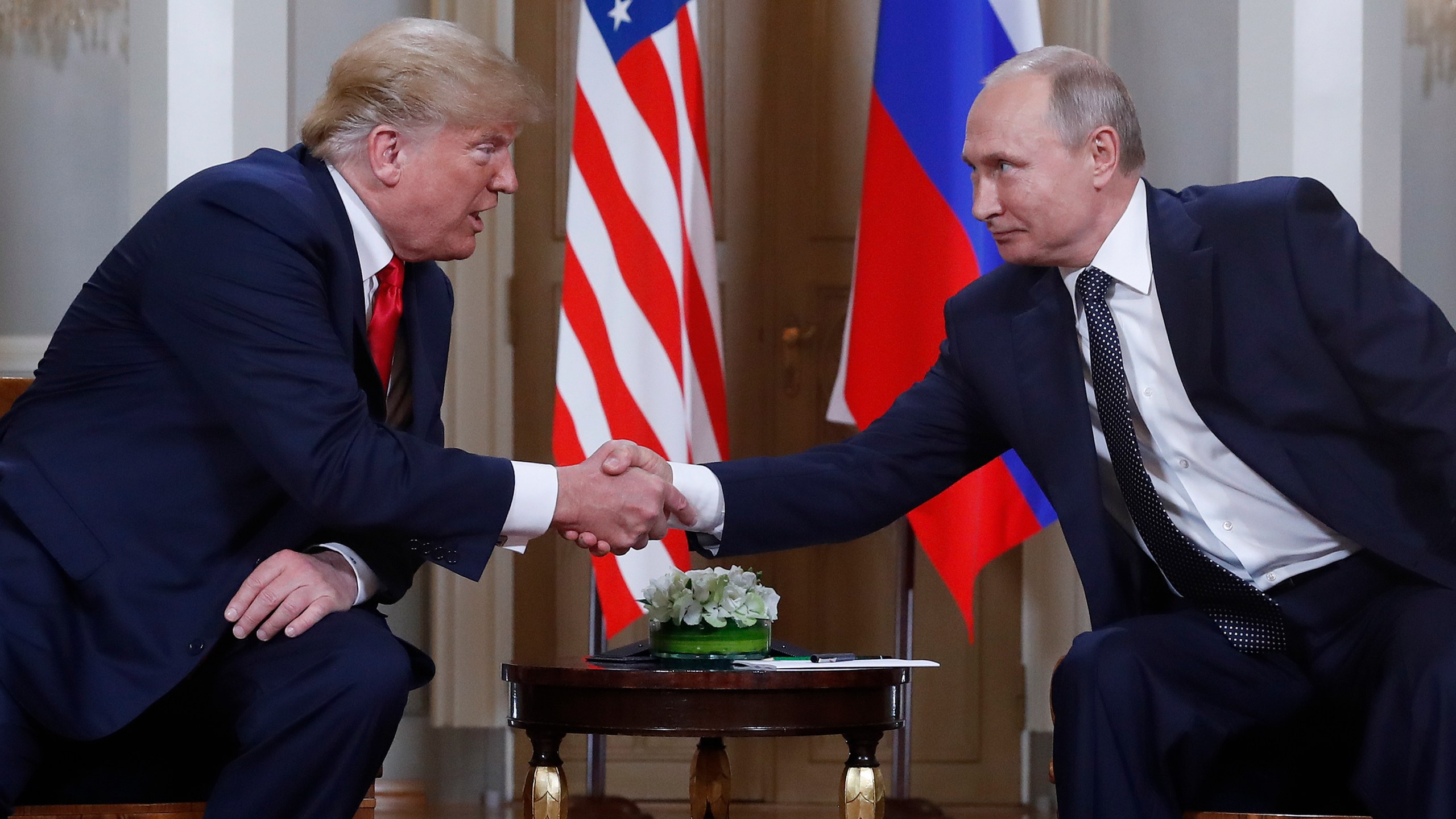 FILE - U.S. President Donald Trump, left, and Russian President Vladimir Putin, right, shake hands at the beginning of a meeting at the Presidential Palace in Helsinki, Finland, July 16, 2018. (AP Photo/Pablo Martinez Monsivais, File)