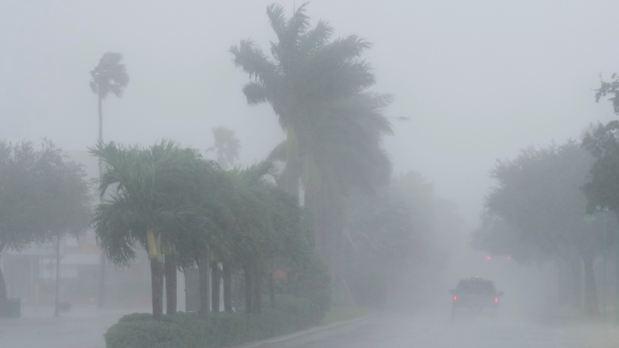 A Lee County Sheriff's officer patrols the streets of Cape Coral, Fla., as heavy rain falls ahead of Hurricane Milton, Wednesday, Oct. 9, 2024. (AP Photo/Marta Lavandier)