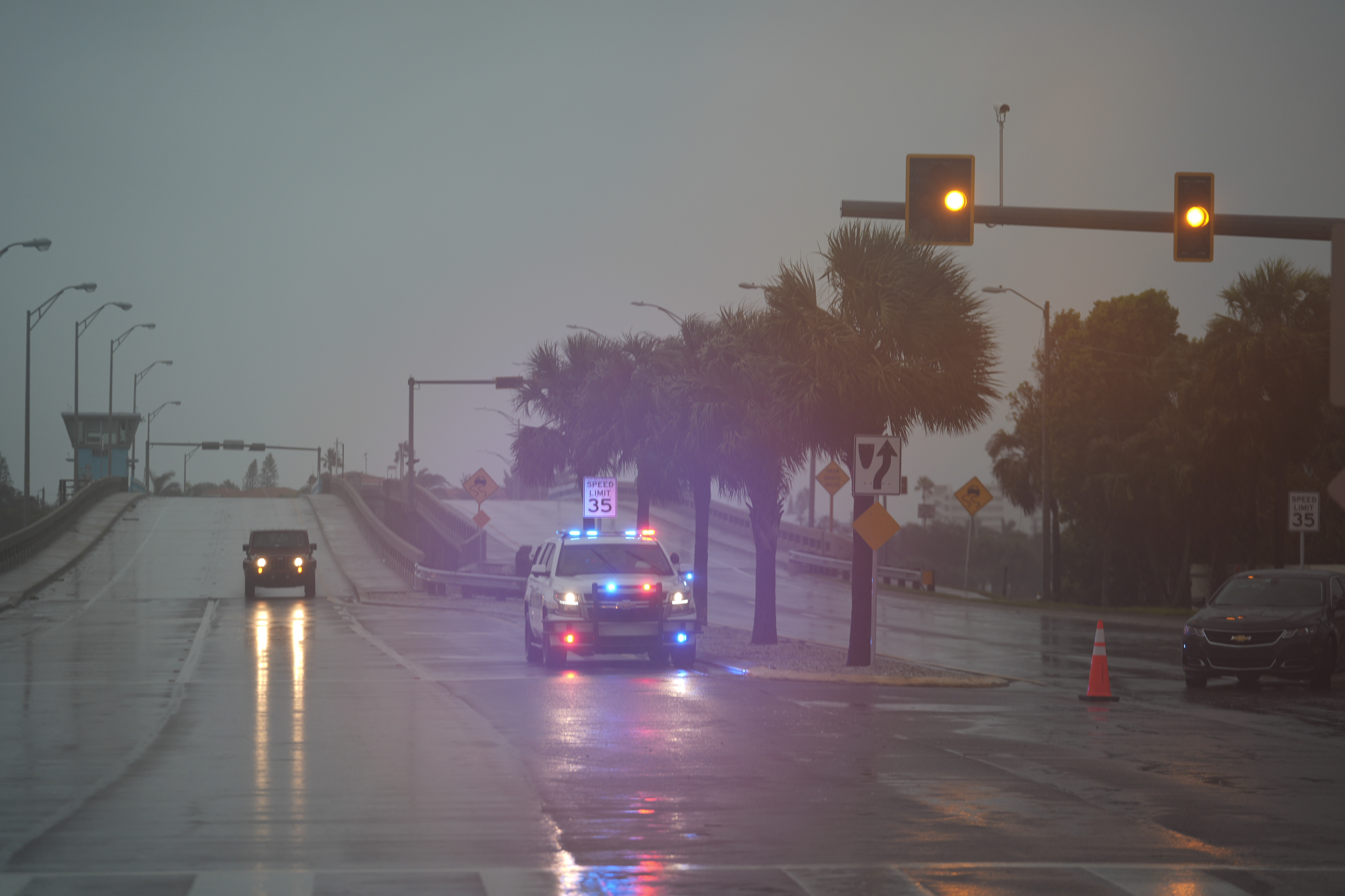 Police block off a bridge leading to the barrier island of St. Pete Beach, Fla., ahead of the arrival of Hurricane Milton, in South Pasadena, Fla., Wednesday, Oct. 9, 2024. (AP Photo/Rebecca Blackwell)