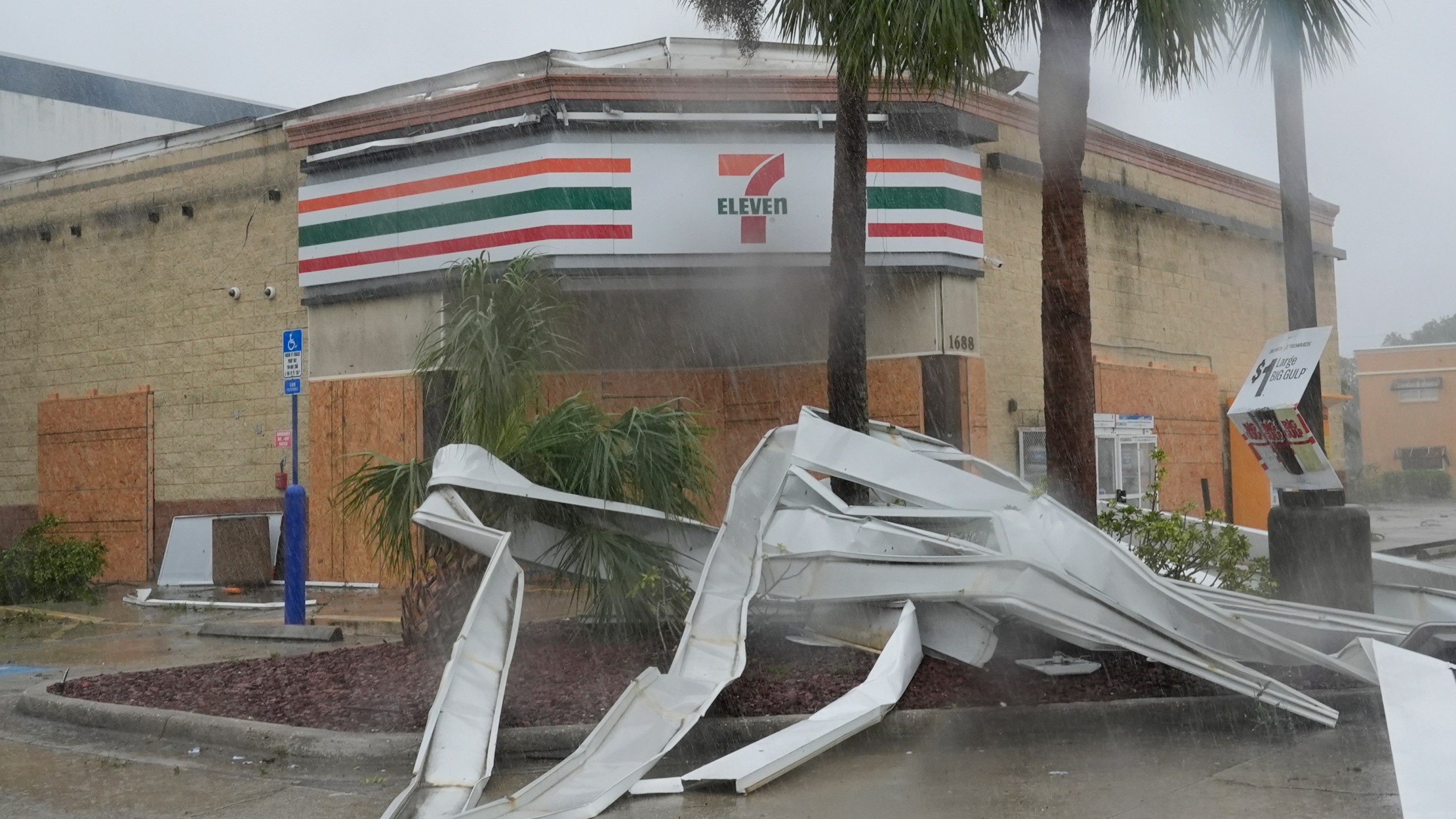 An apparent tornado caused by Hurricane Milton, tore the awning off a 7-Eleven convenient store, Wednesday, Oct. 9, 2024, in Cape Coral, Fla. (AP Photo/Marta Lavandier)