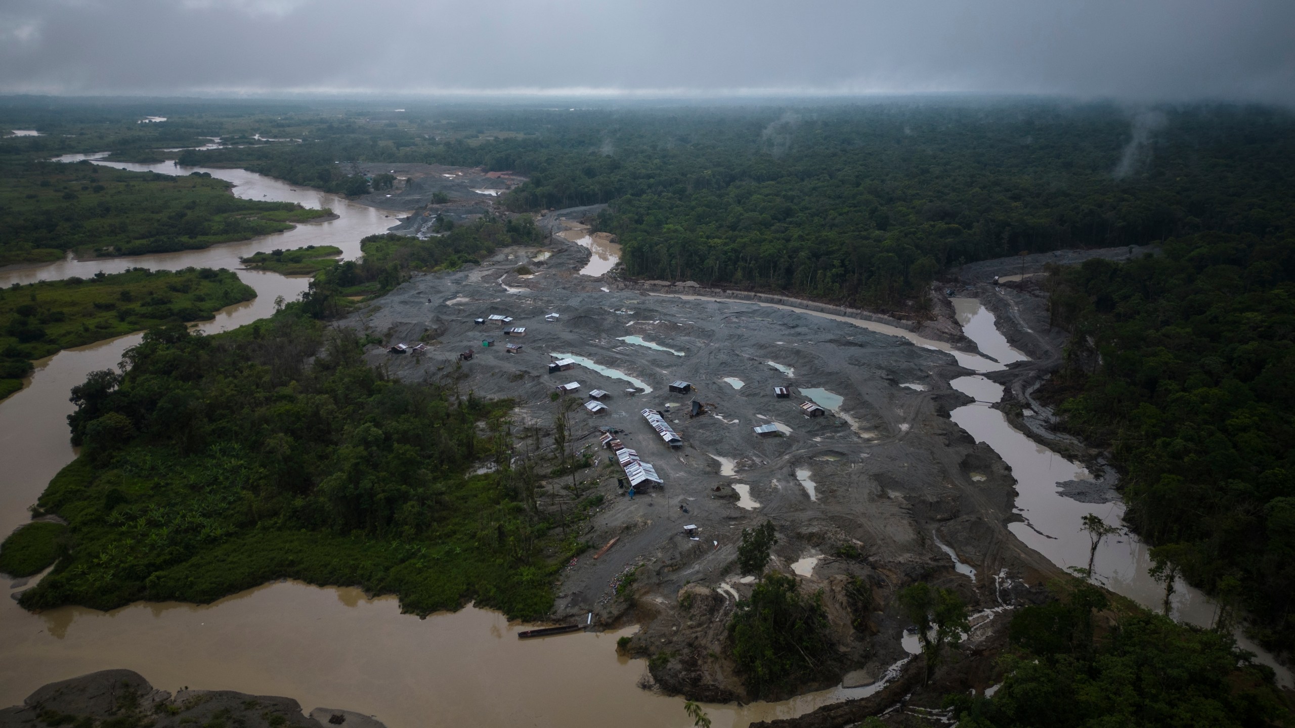 An illegal mining camp, sits along the Quito River, near Paimado, Colombia, Monday, Sept. 23, 2024. (AP Photo/Ivan Valencia)