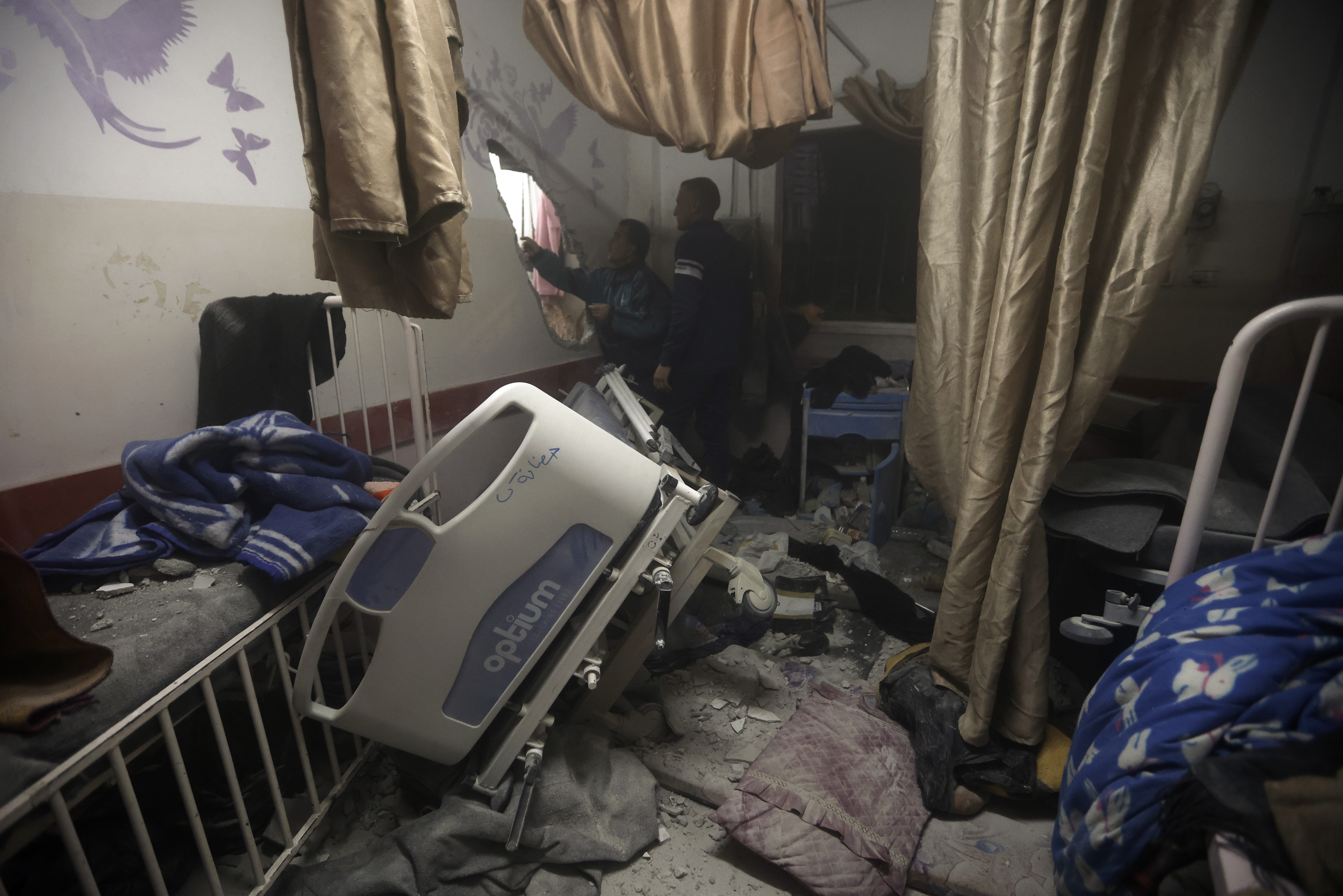 FILE - Palestinian paramedics inspect damage in the patient rooms caused by the Israeli strikes on the maternity ward at Nasser Hospital in the town of Khan Younis, southern Gaza Strip, Sunday, Dec. 17, 2023. (AP Photo/Mohammed Dahman, File)