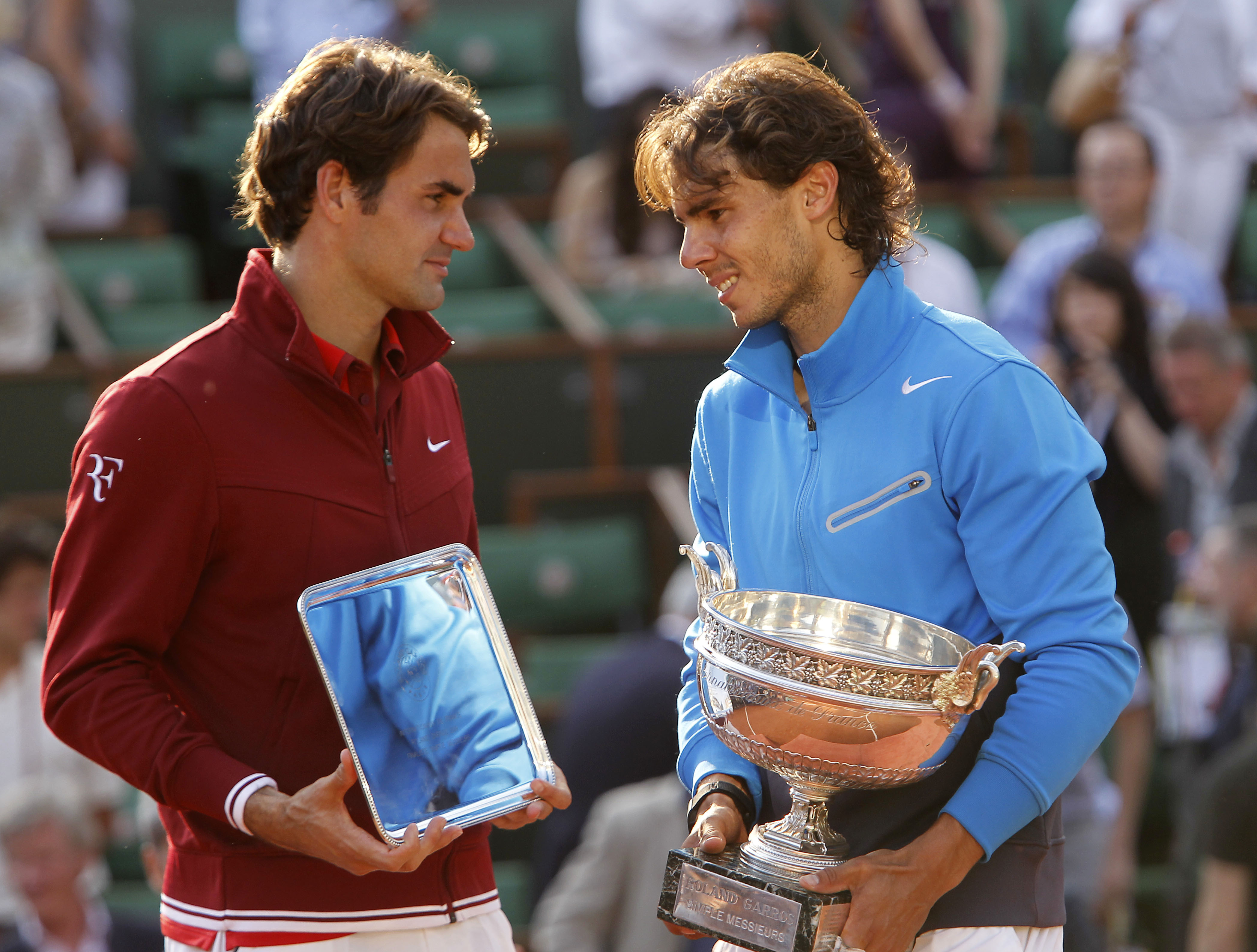 FILE - Spain's Rafael Nadal, right, and Switzerland's Roger Federer pose with their trophies after the men's final match for the French Open tennis tournament at Roland Garros stadium in Paris, June 5, 2011, as Nadal has announced he will retire from tennis at age 38 following the Davis Cup finals in November. (AP Photo/Lionel Cironneau, File)