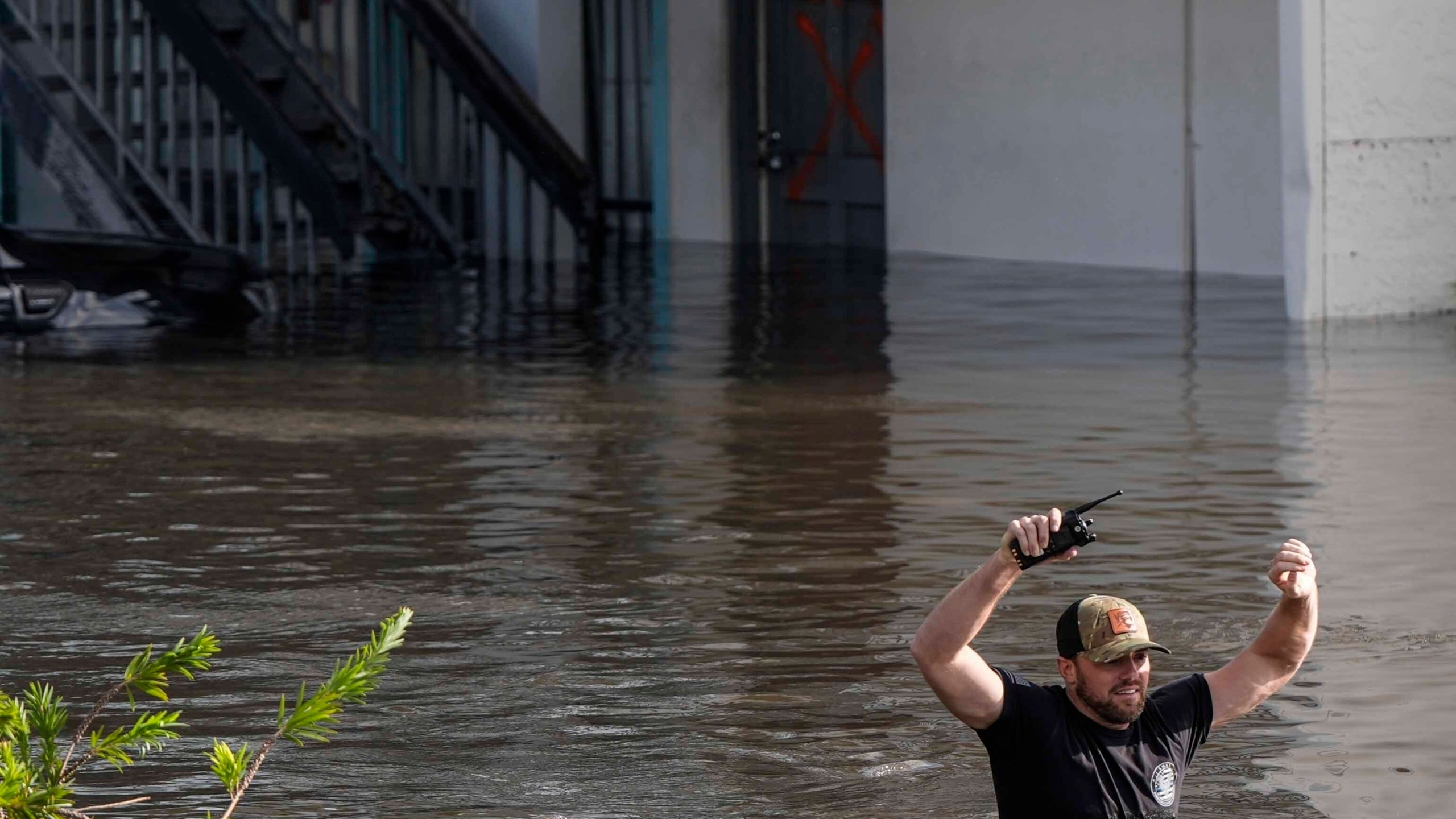 A water rescue team member walks through floodwaters at an apartment complex in the aftermath of Hurricane Milton, Thursday, Oct. 10, 2024, in Clearwater, Fla. (AP Photo/Mike Stewart)