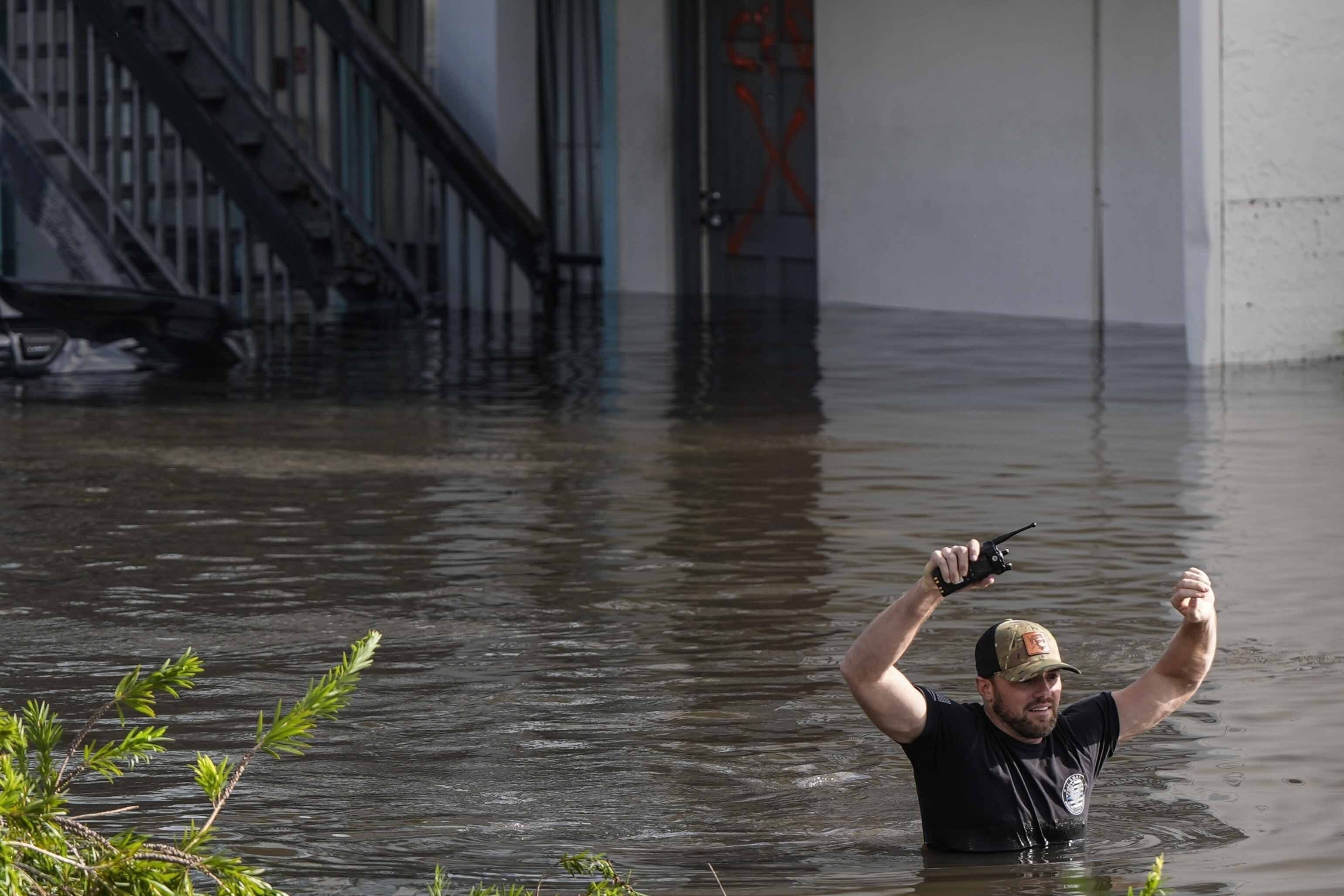 A water rescue team member walks through floodwaters at an apartment complex in the aftermath of Hurricane Milton, Thursday, Oct. 10, 2024, in Clearwater, Fla. (AP Photo/Mike Stewart)