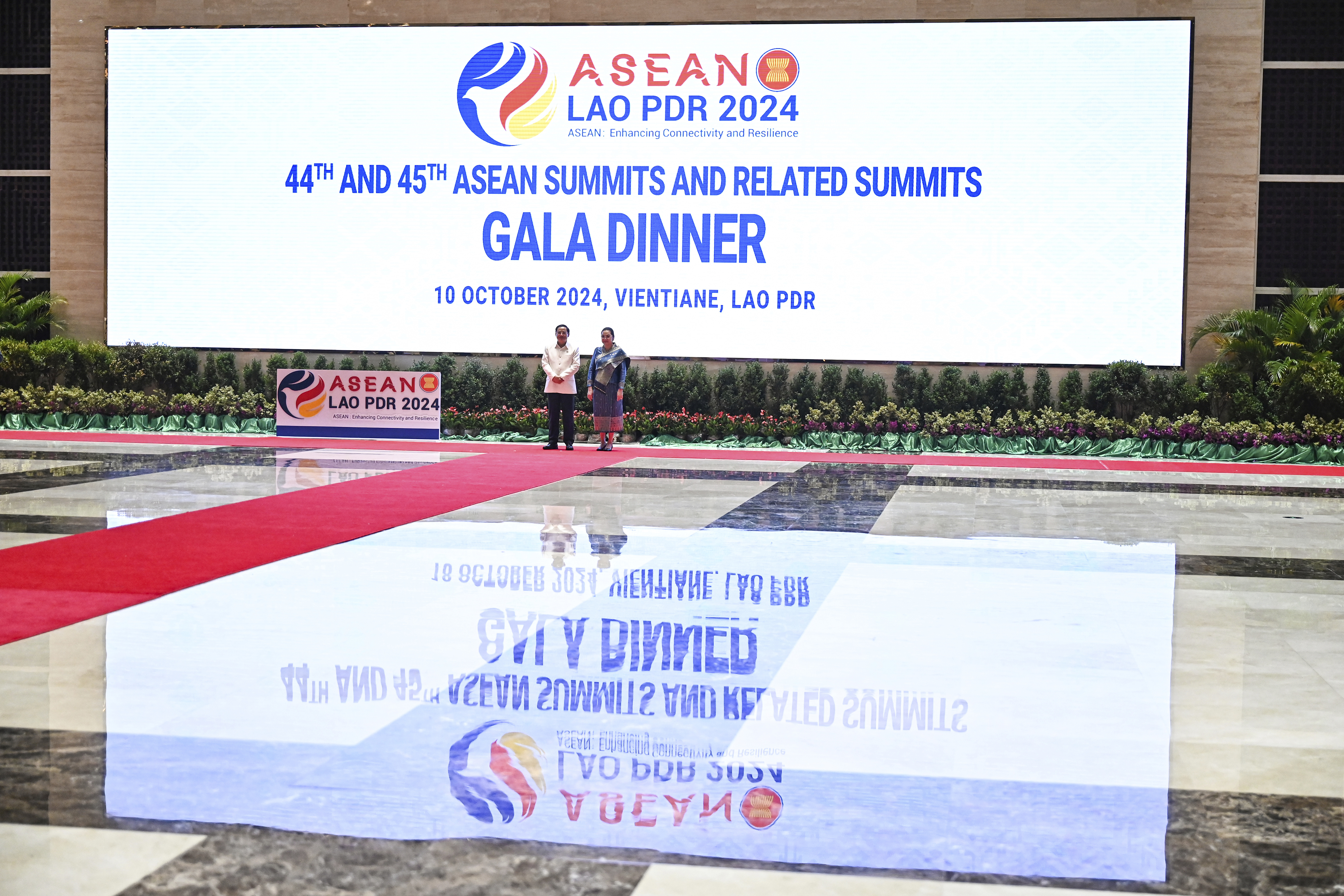 Laos' Prime Minister Sonexay Siphandone and his wife Vandara Siphandone wait to welcome guests for the gala dinner, during the Southeast Asian Nations (ASEAN) Summit in Vientiane, Laos, Thursday, Oct. 10, 2024. (Tang Chhin Sothy, Pool Photo via AP)