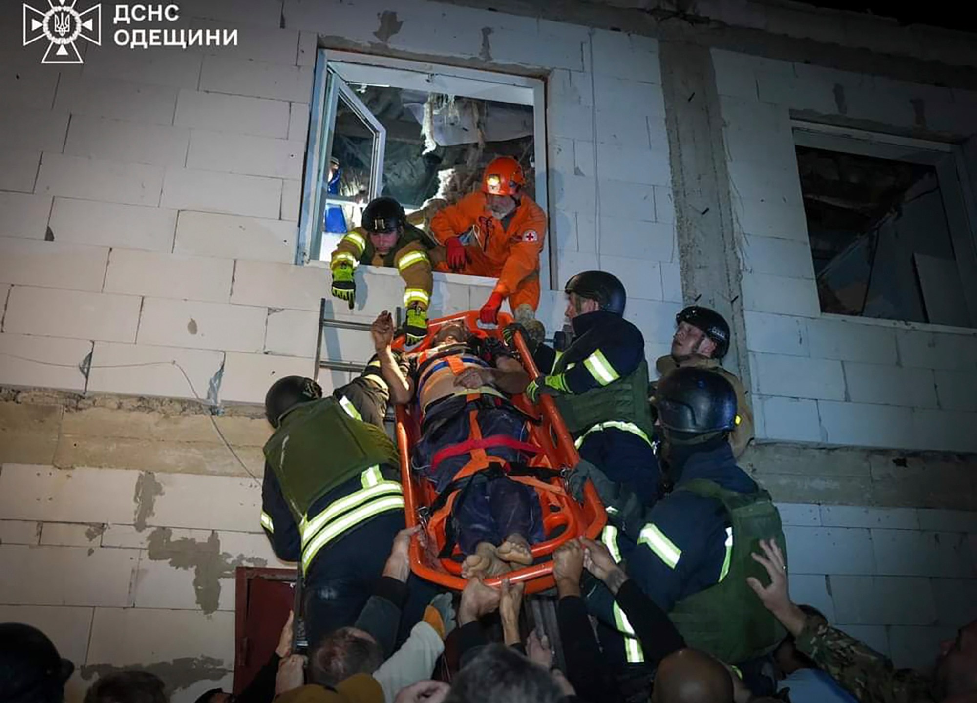 In this photo provided by the Ukrainian Emergency Service, Emergency workers carry a wounded resident after Russian missile attack in Odesa, Ukraine, late Thursday, Oct. 10, 2024. Four Russian missile and drone attacks on the Odesa region this week have killed 14 people and wounded around 20, according to local officials. (Ukrainian Emergency Service via AP)