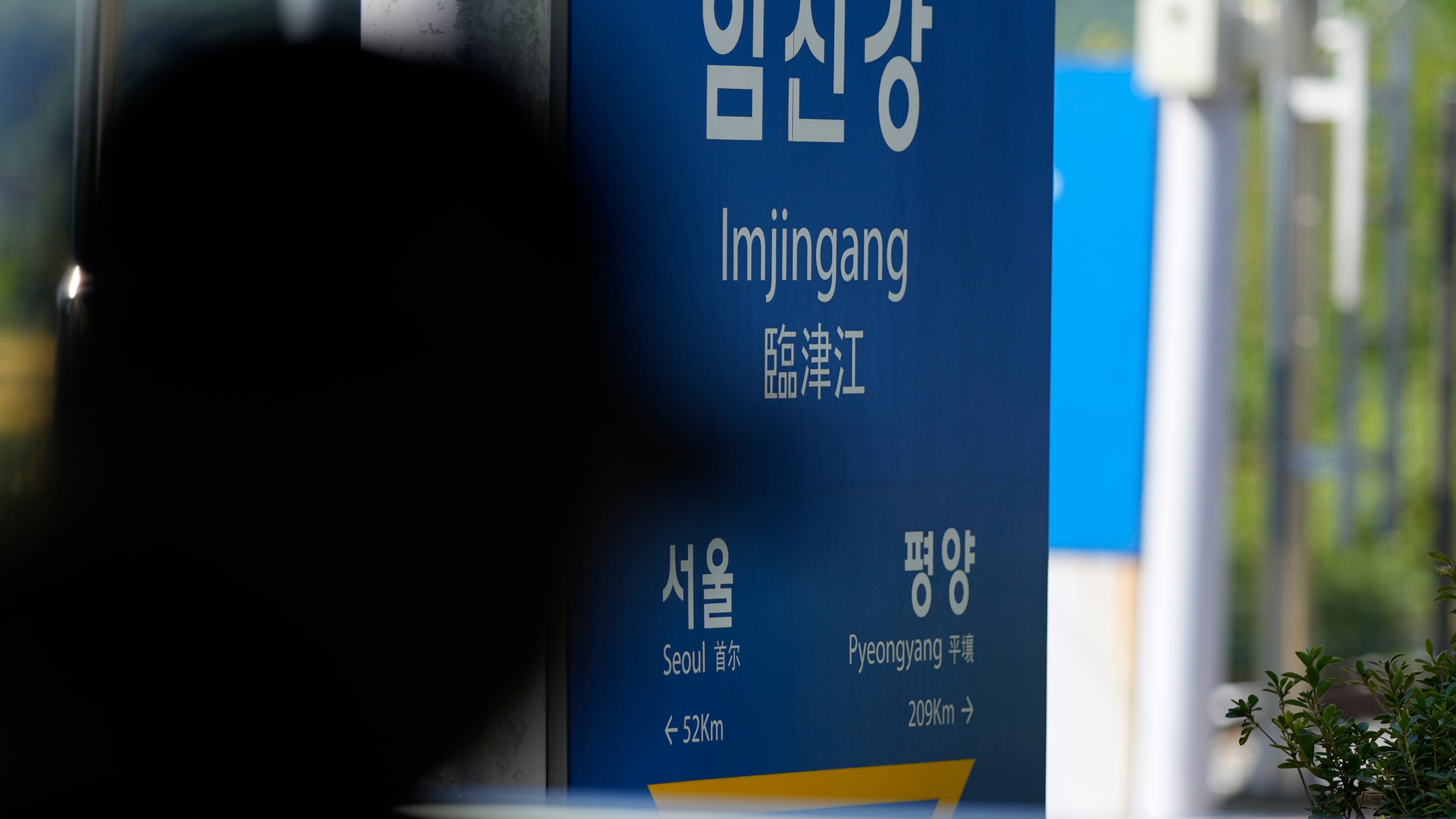 A visitor walks past near a signboard showing the distance to North Korea's capital Pyongyang and to South Korea's capital Seoul from Imjingang Station in Paju, South Korea, Wednesday, Oct. 9, 2024. (AP Photo/Lee Jin-man)