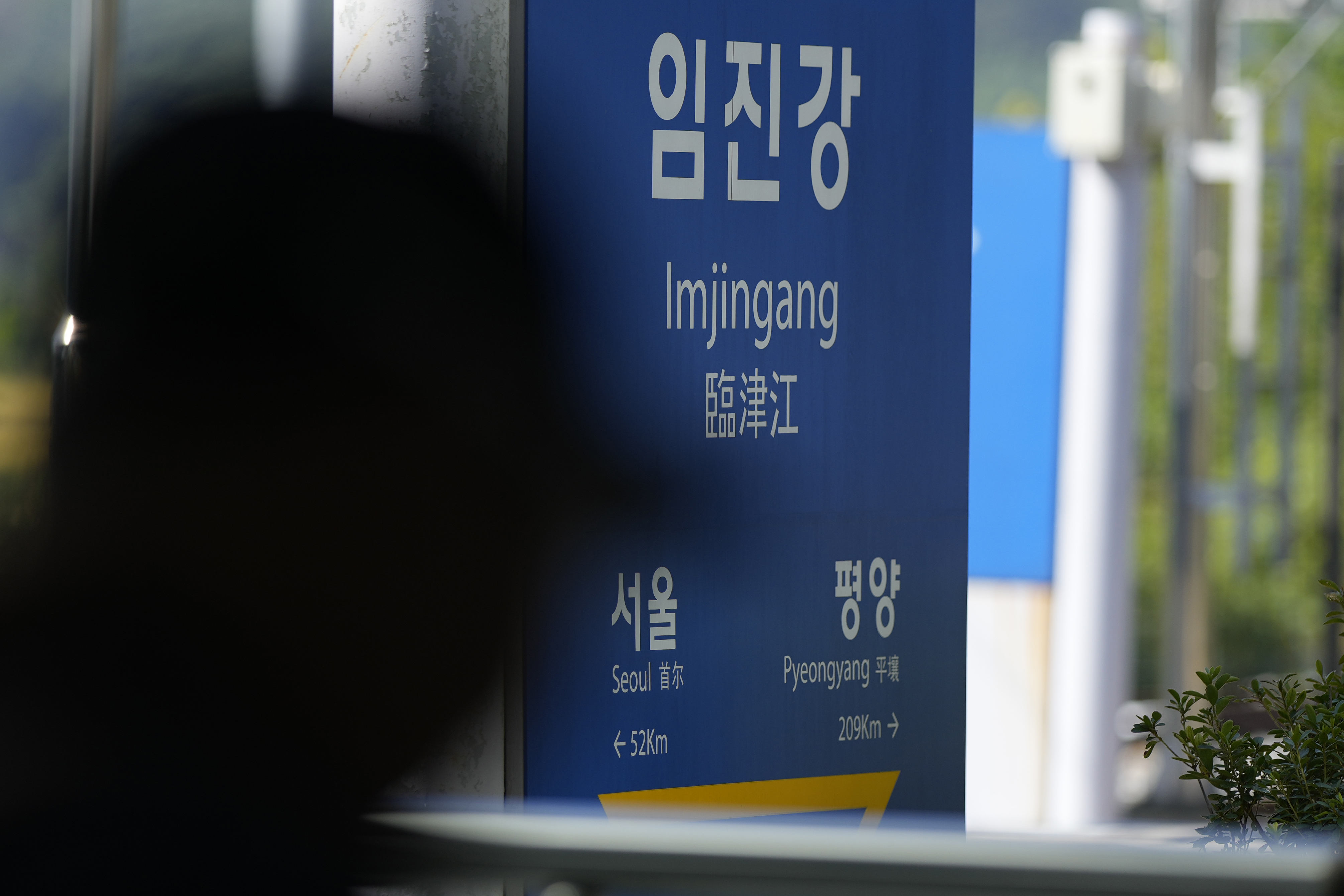 A visitor walks past near a signboard showing the distance to North Korea's capital Pyongyang and to South Korea's capital Seoul from Imjingang Station in Paju, South Korea, Wednesday, Oct. 9, 2024. (AP Photo/Lee Jin-man)