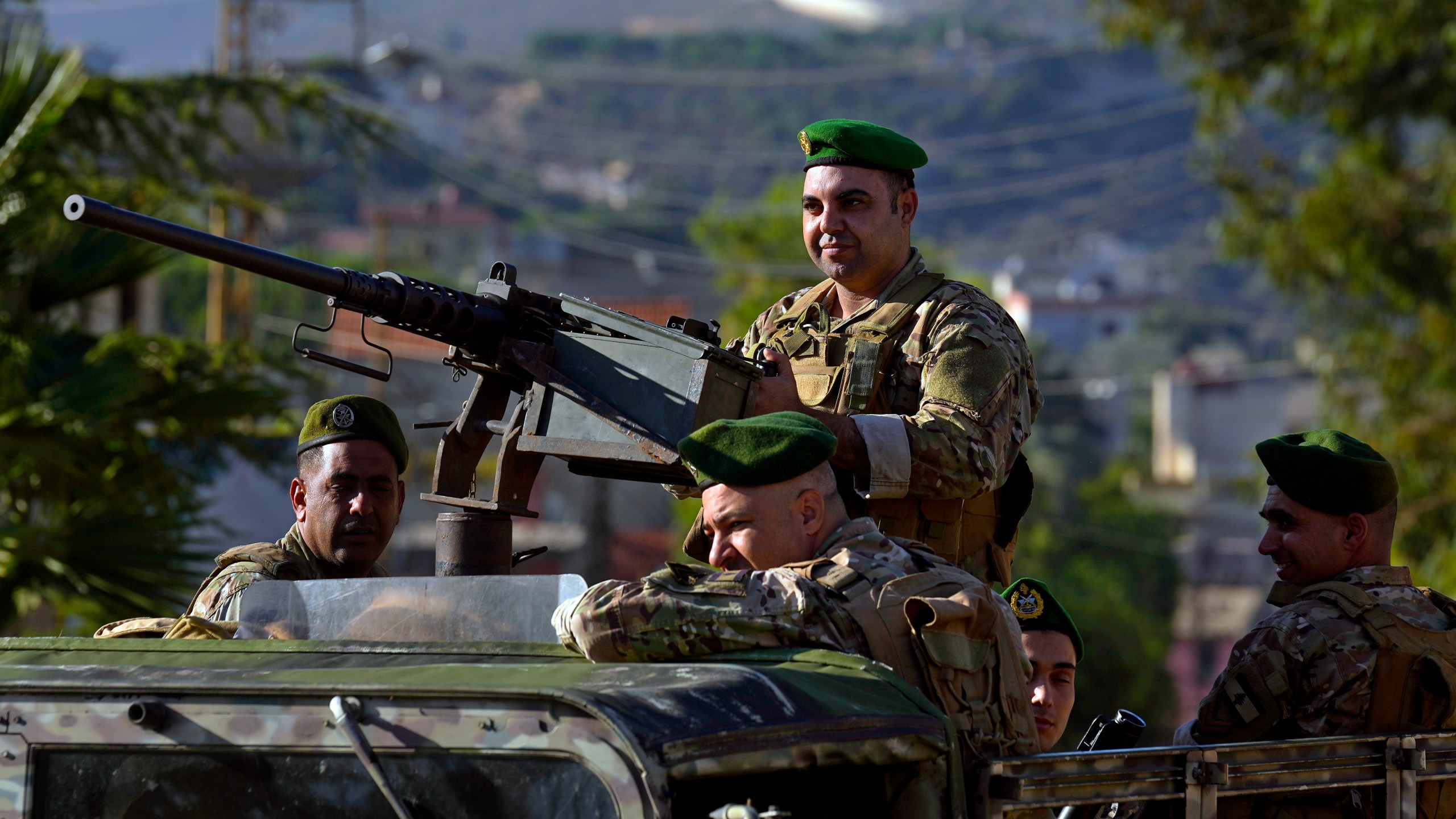 FILE - Lebanese army soldiers sit on their armored vehicle as they patrol the Lebanese side of the Lebanese-Israeli border in the southern village of Kfar Kila, Lebanon, on Oct. 13, 2023. (AP Photo/Bilal Hussein, File)