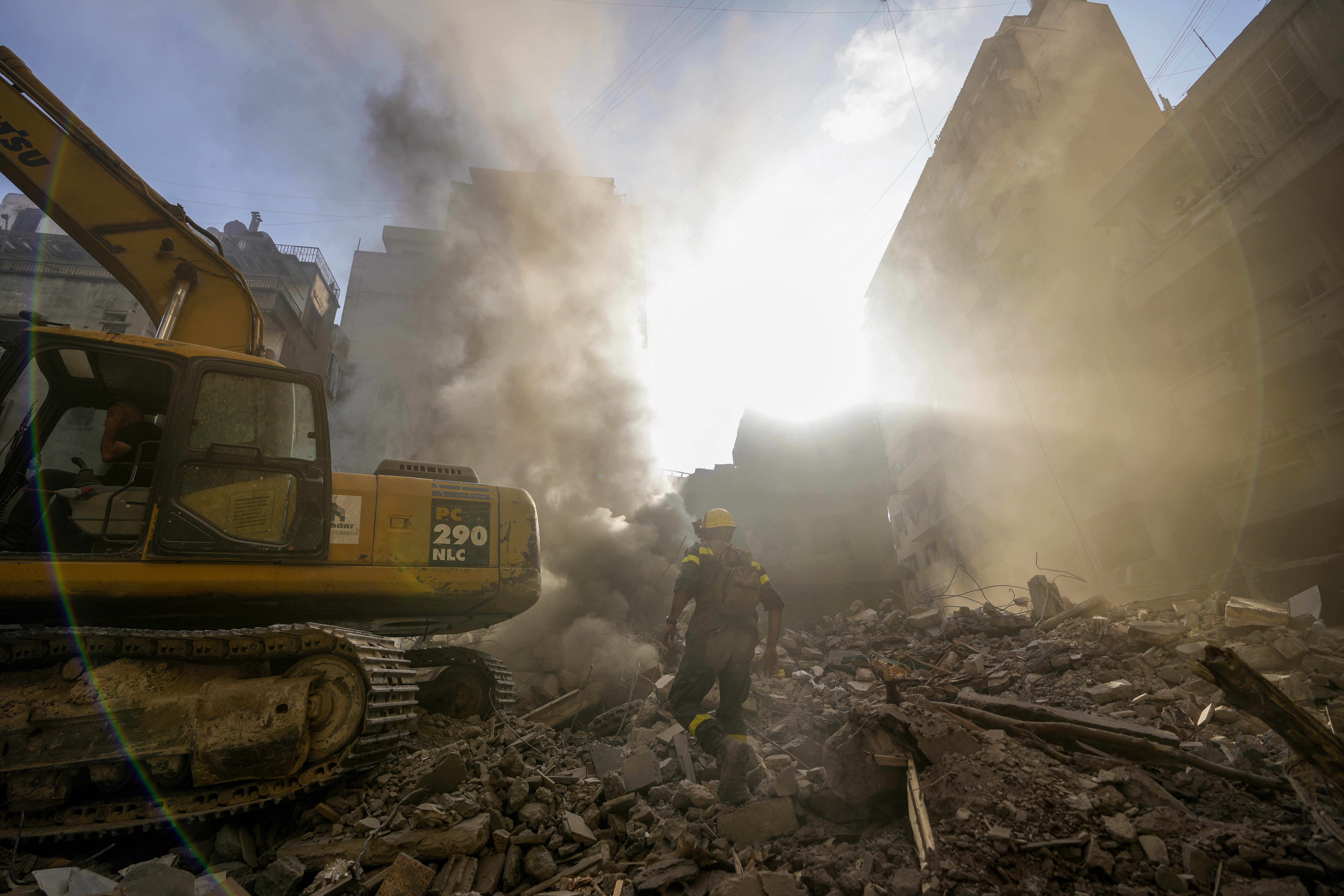 Rescue workers search for victims at the site of Thursday's Israeli airstrike in Beirut, Lebanon, Friday, Oct. 11, 2024. (AP Photo/Hassan Ammar)