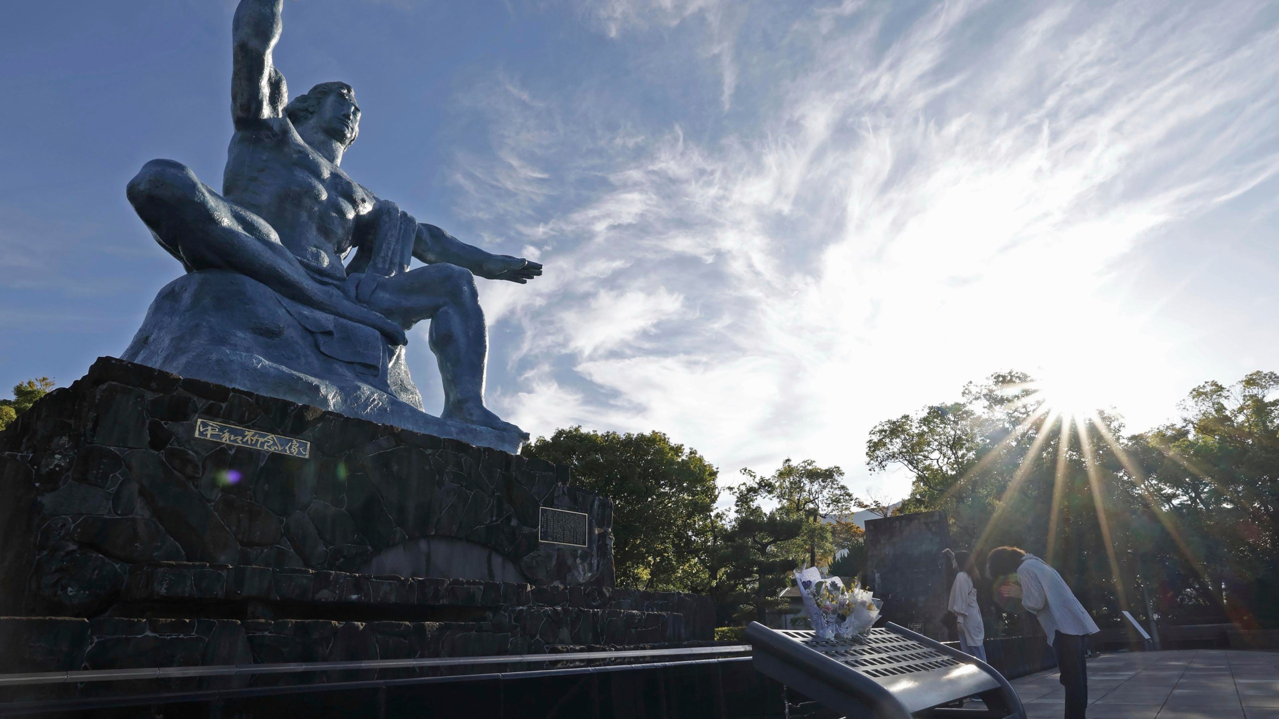 A visitor prays in front of the Peace Statue at the Peace Park in Nagasaki, southern Japan Saturday, Oct. 12, 2024, a day after the Nobel Peace Prize was awarded to Nihon Hidankyo, a Japanese organization of survivors of the U.S. atomic bombings of Hiroshima and Nagasaki, for its activism against nuclear weapons. (Kyodo News via AP)