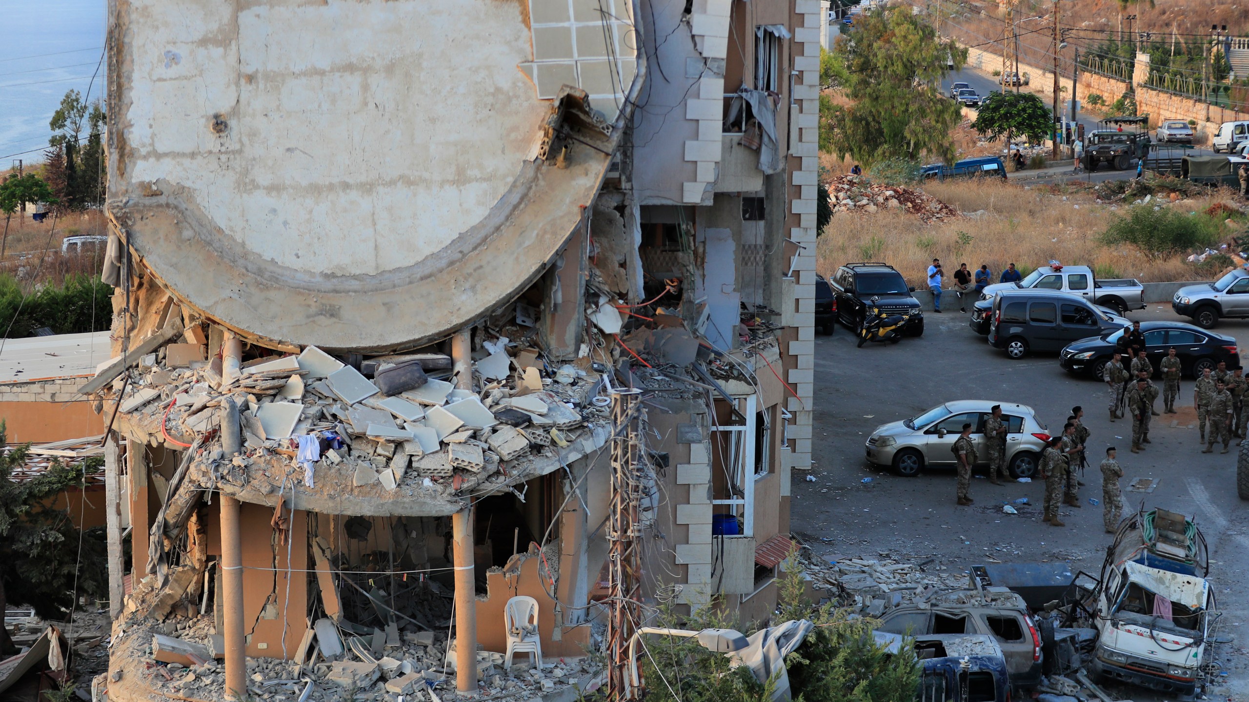 Lebanese army soldiers deploy around a destroyed building hit by an Israeli airstrike, in Barja village, south of Beirut, Lebanon, Saturday, Oct. 12, 2024. (AP Photo/Mohammed Zaatari)