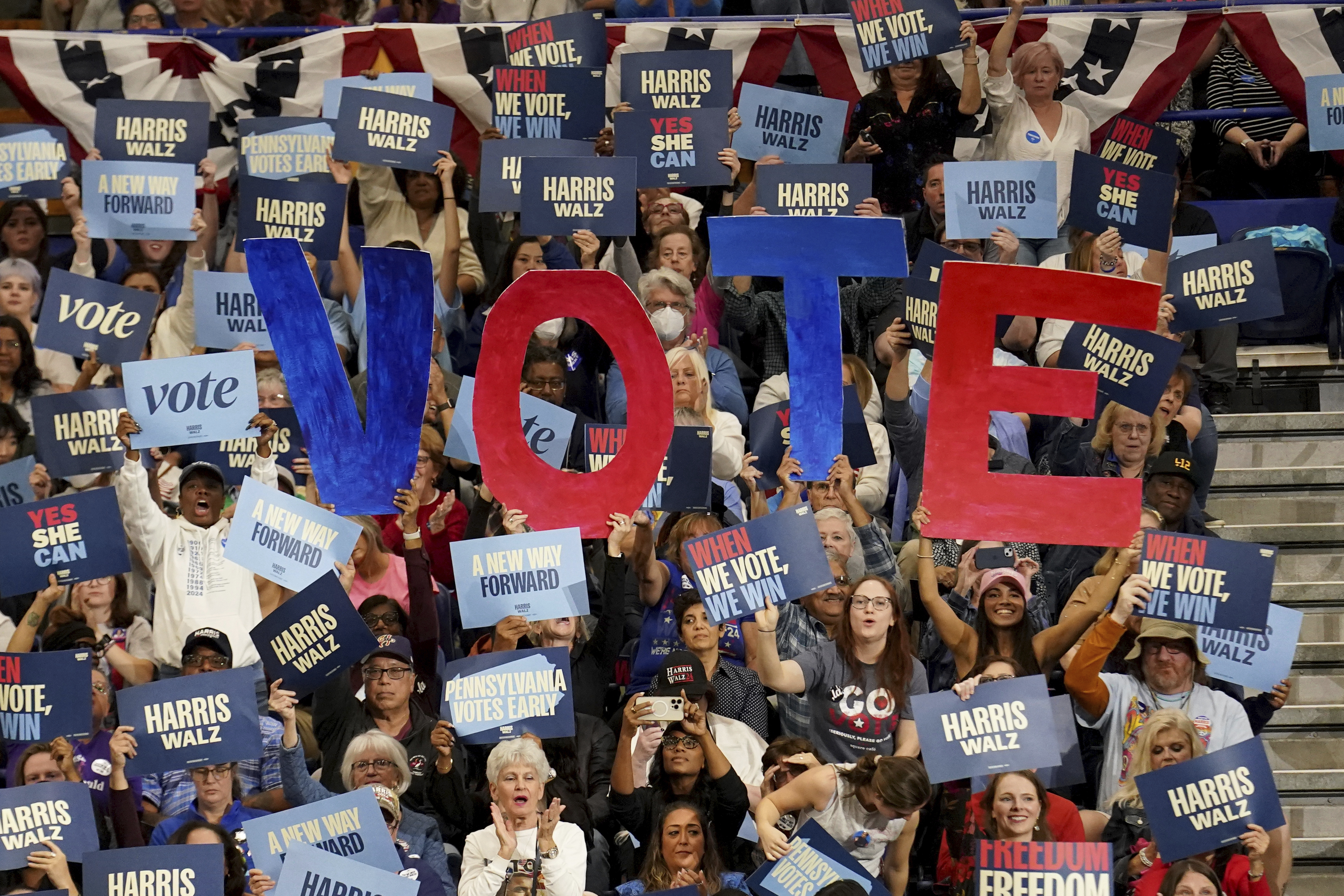 Attendees hold signs as former President Barack Obama speaks during a campaign rally supporting Democratic presidential nominee Vice President Kamala Harris, Thursday, Oct. 10, 2024, at the University of Pittsburgh's Fitzgerald Field House in Pittsburgh. (AP Photo/Matt Freed)