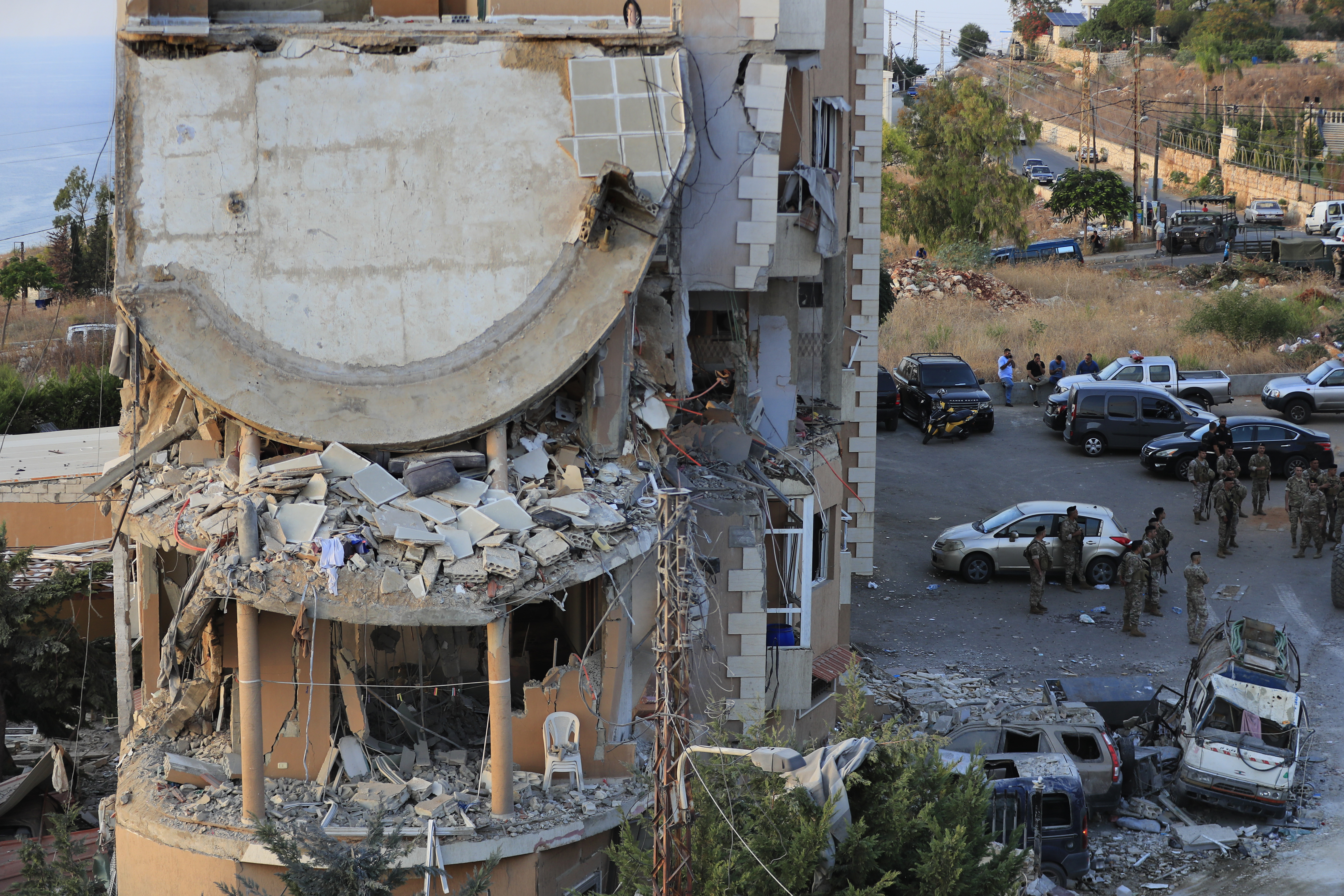 Lebanese army soldiers deploy around a destroyed building hit by an Israeli airstrike, in Barja village, south of Beirut, Lebanon, Saturday, Oct. 12, 2024. (AP Photo/Mohammed Zaatari)