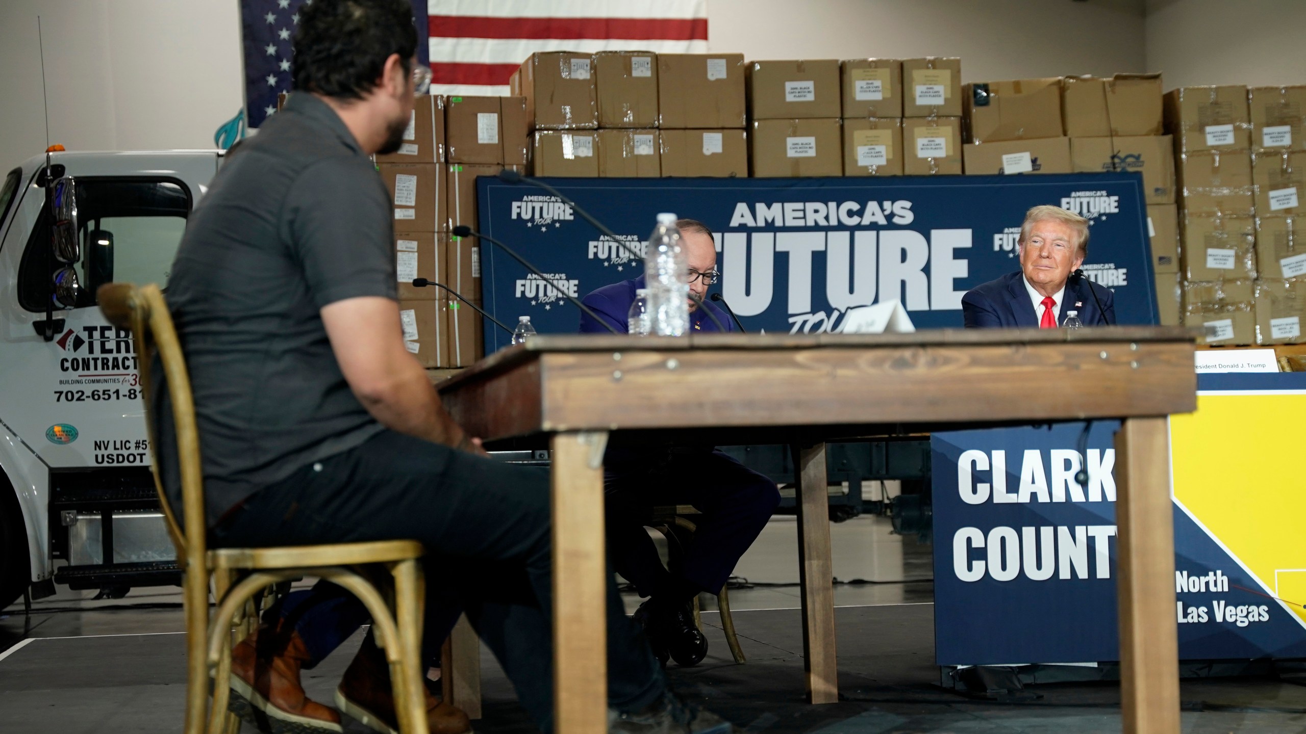 Elias Trujillo, left, speaks as Republican presidential nominee former President Donald Trump, from right, and Goya Foods CEO Robert Unanue listen during a campaign event, Saturday, Oct. 12, 2024, in North Las Vegas, Nev. (AP Photo/Lucas Peltier)