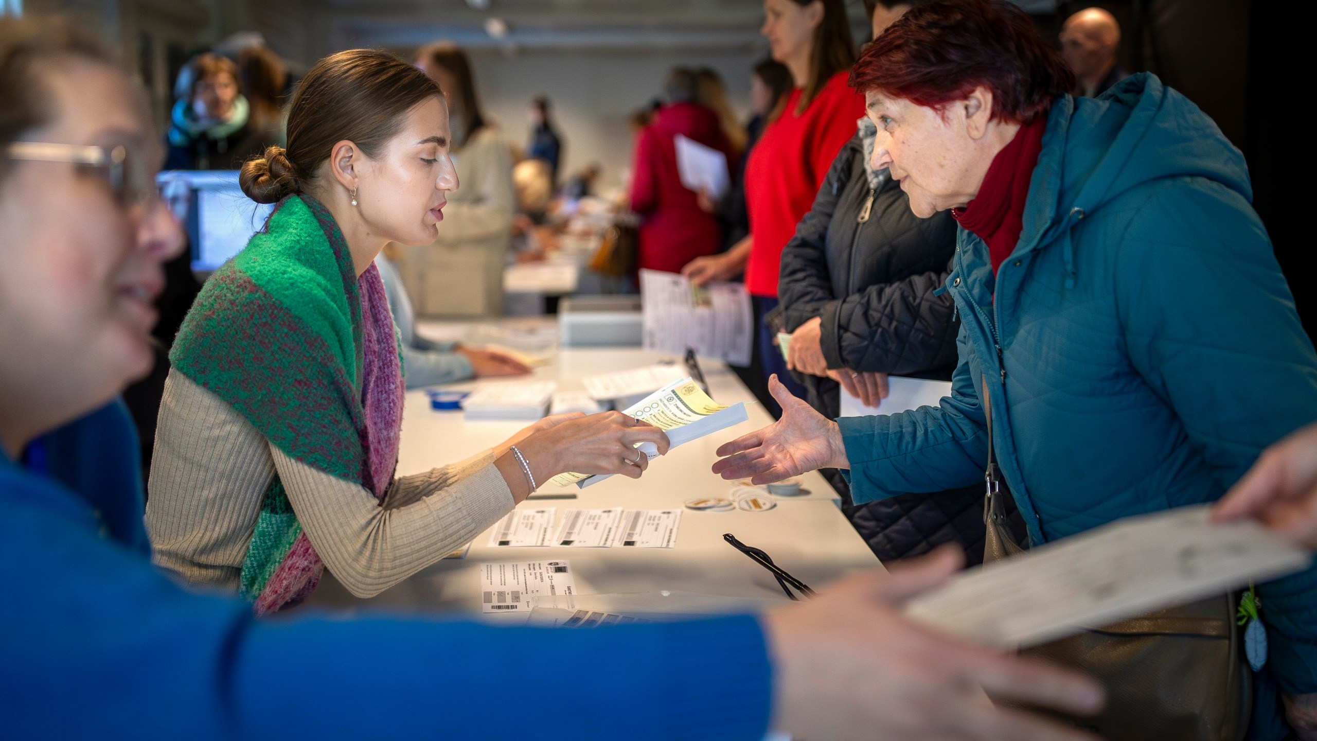 FILE - A woman arrives at a polling station during the advance parliamentary elections in Vilnius, Lithuania, Tuesday, Oct. 8, 2024. (AP Photo/Mindaugas Kulbis, File)