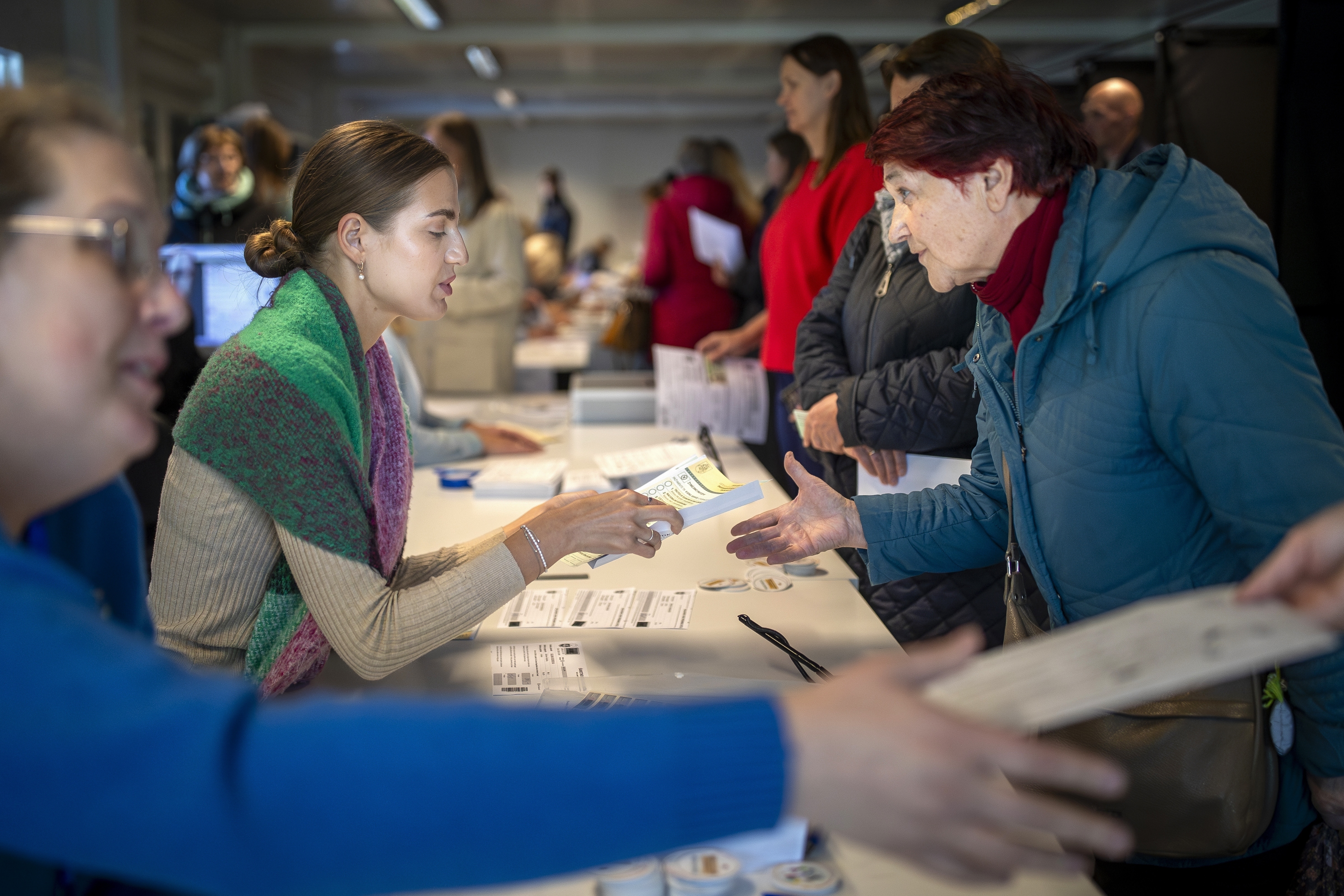 FILE - A woman arrives at a polling station during the advance parliamentary elections in Vilnius, Lithuania, Tuesday, Oct. 8, 2024. (AP Photo/Mindaugas Kulbis, File)