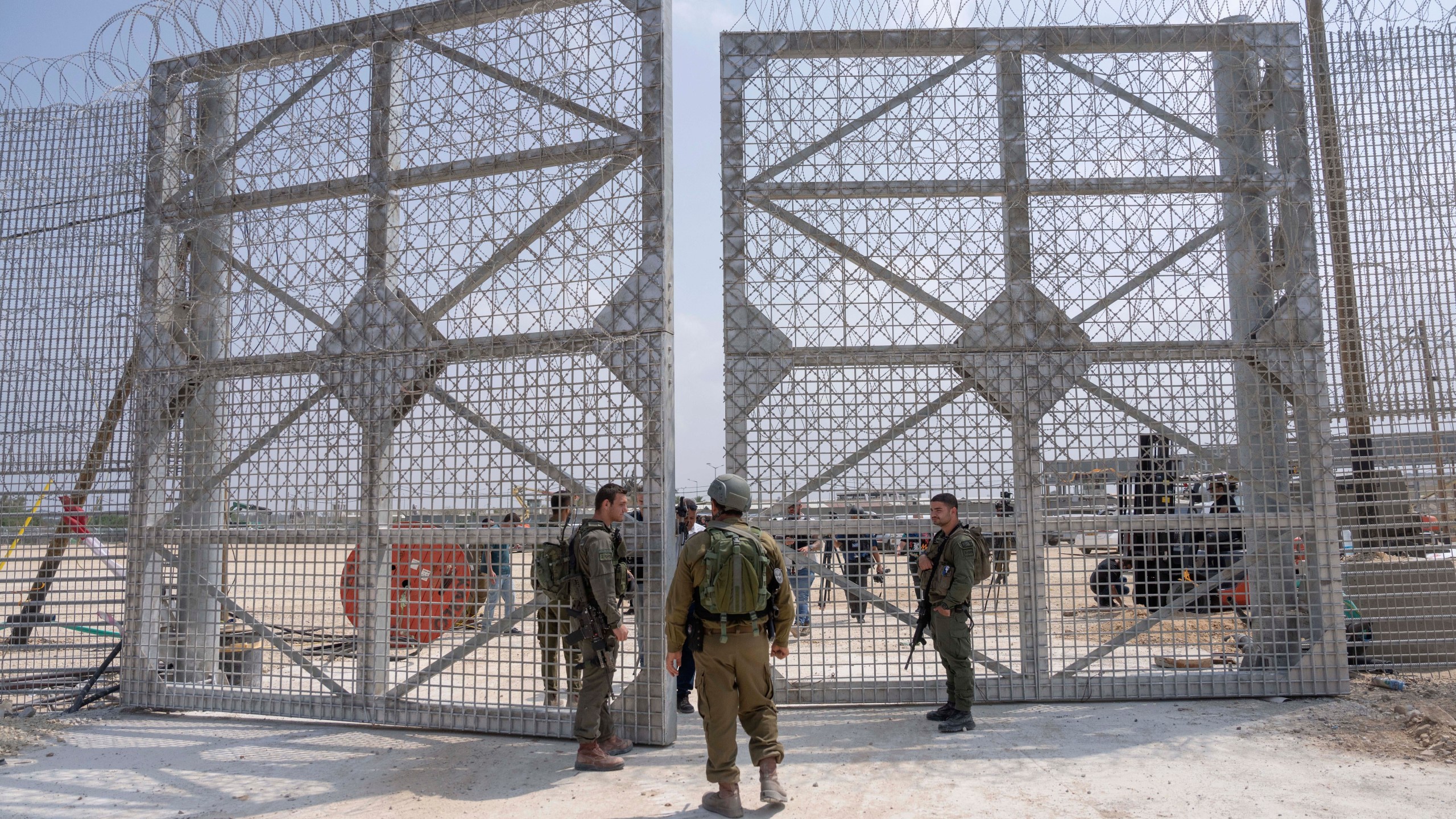 FILE - Israeli soldiers gather near a gate to walks through an inspection area for trucks carrying humanitarian aid supplies bound for the Gaza Strip, on the Israeli side of the Erez crossing into northern Gaza, on May 1, 2024. (AP Photo/Ohad Zwigenberg, File)