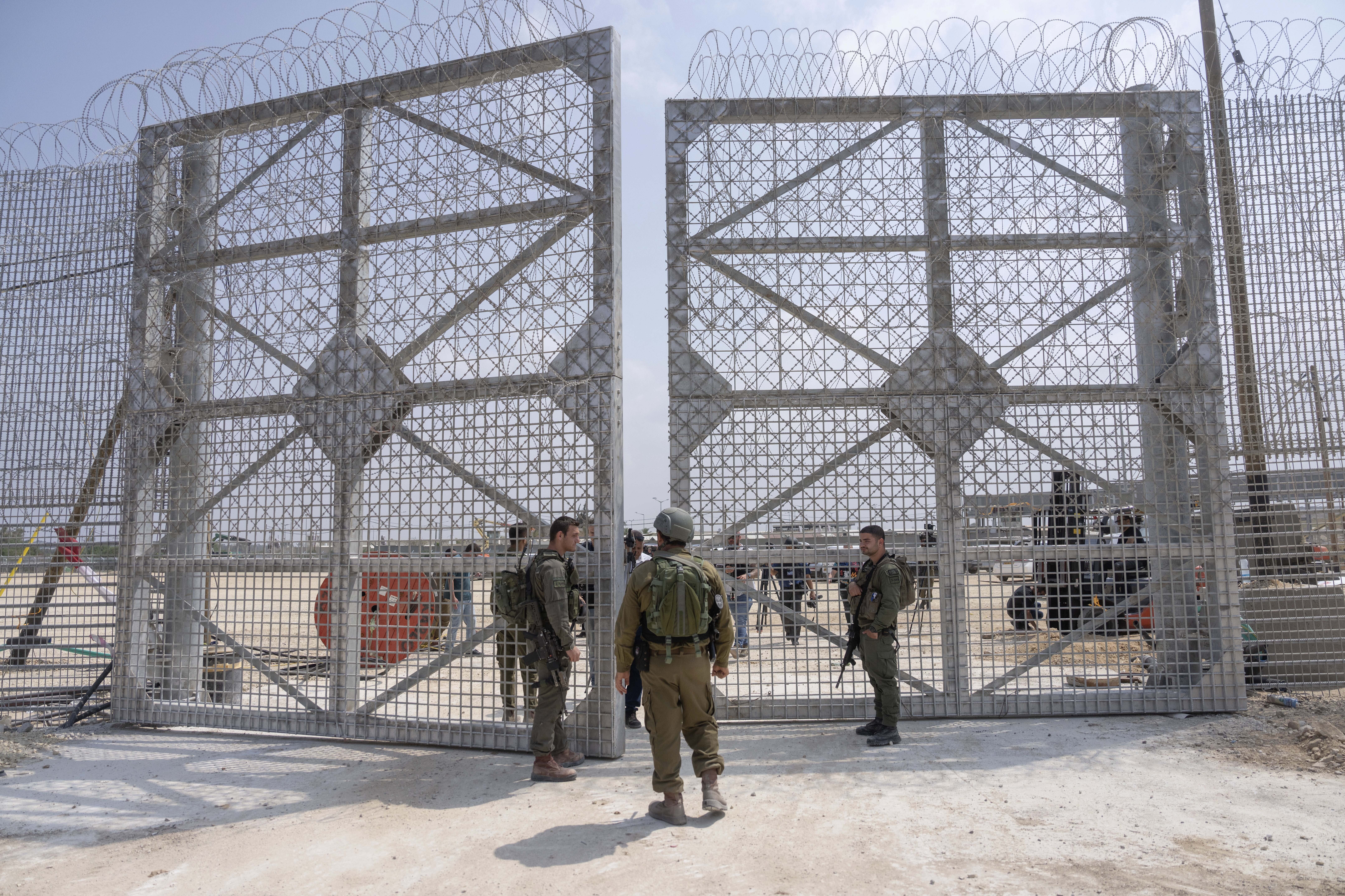 FILE - Israeli soldiers gather near a gate to walks through an inspection area for trucks carrying humanitarian aid supplies bound for the Gaza Strip, on the Israeli side of the Erez crossing into northern Gaza, on May 1, 2024. (AP Photo/Ohad Zwigenberg, File)