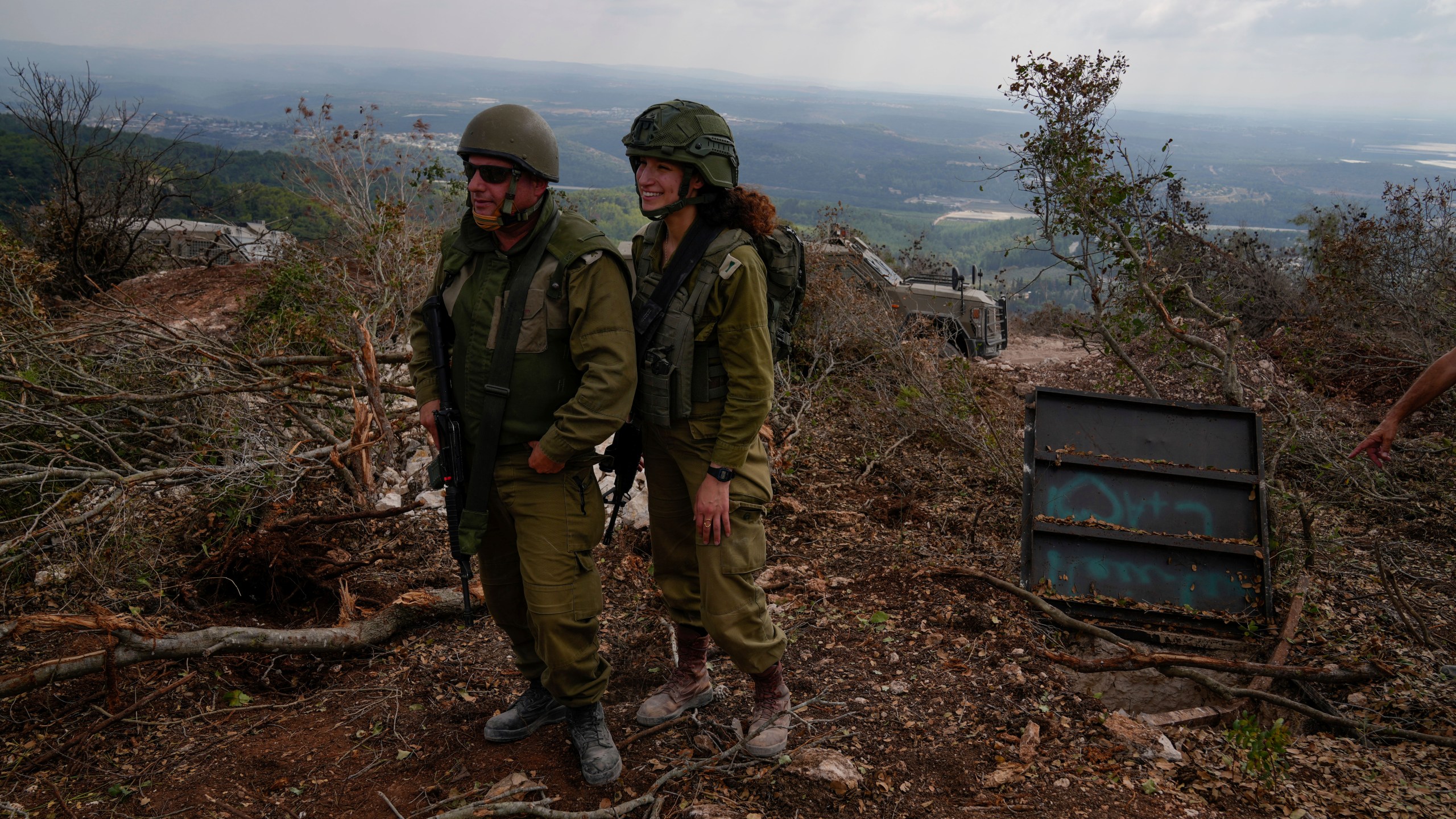 Israeli soldiers display what they say is an entrance to a Hezbollah tunnel found during their ground operation in southern Lebanon, near the border with Israel, Sunday, Oct. 13, 2024. (AP Photo/Sam McNeil)