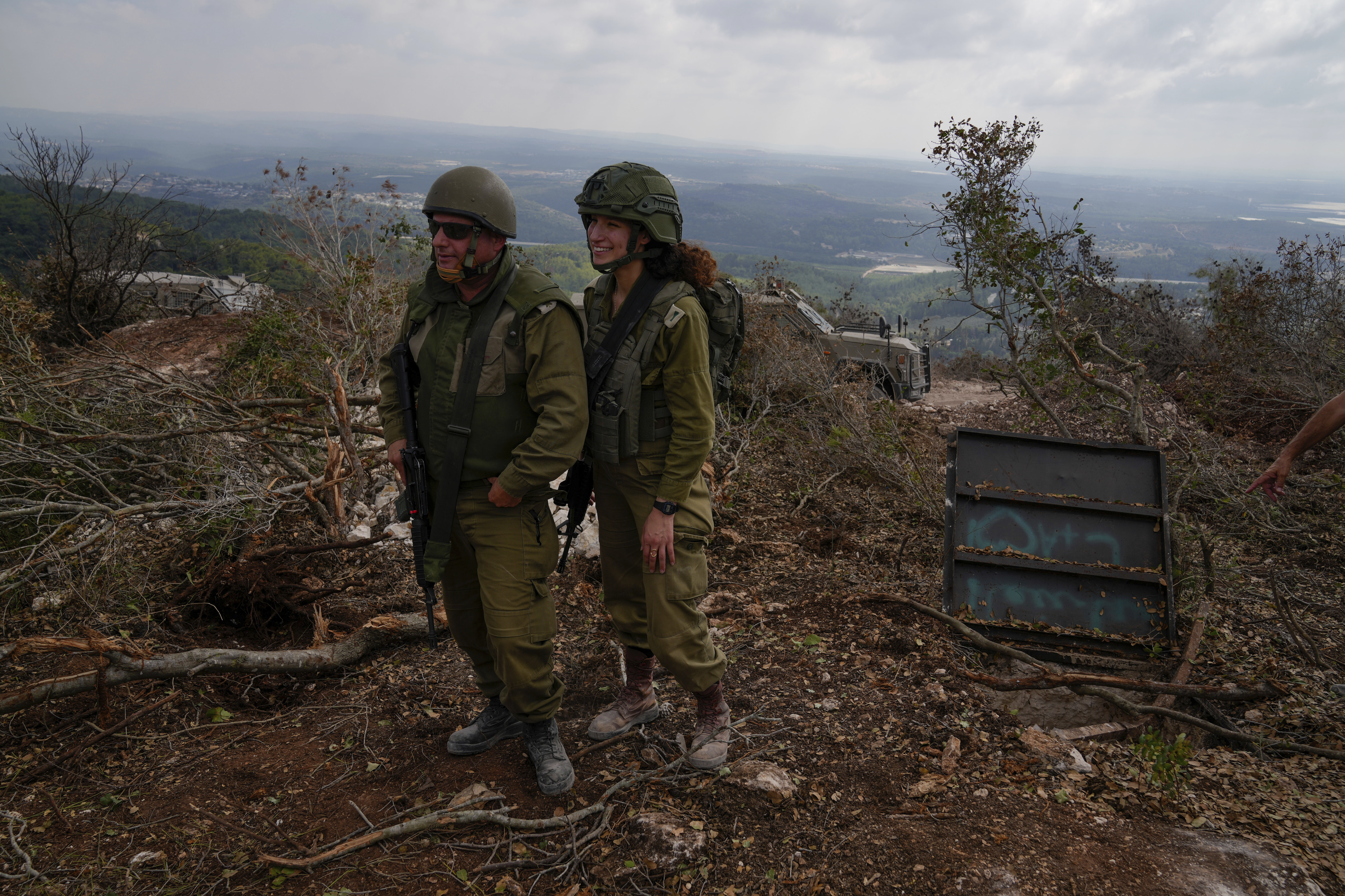 Israeli soldiers display what they say is an entrance to a Hezbollah tunnel found during their ground operation in southern Lebanon, near the border with Israel, Sunday, Oct. 13, 2024. (AP Photo/Sam McNeil)