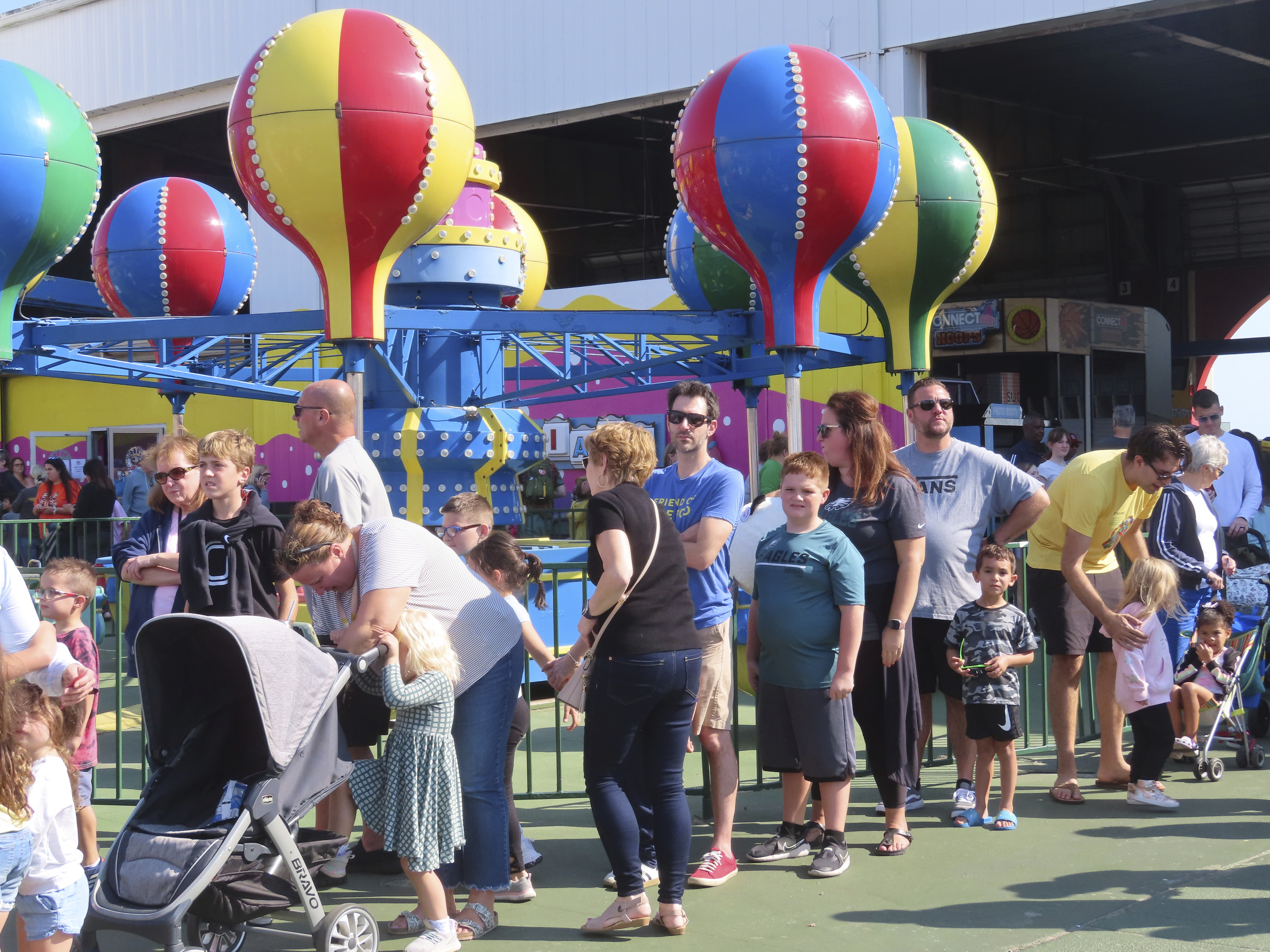 People wait in line to board rides at Gillian's Wonderland, the popular amusement park on the boardwalk in Ocean City, N.J., during its final day of operation before shutting down for good, Sunday, Oct. 13, 2024. (AP Photo/Wayne Parry)