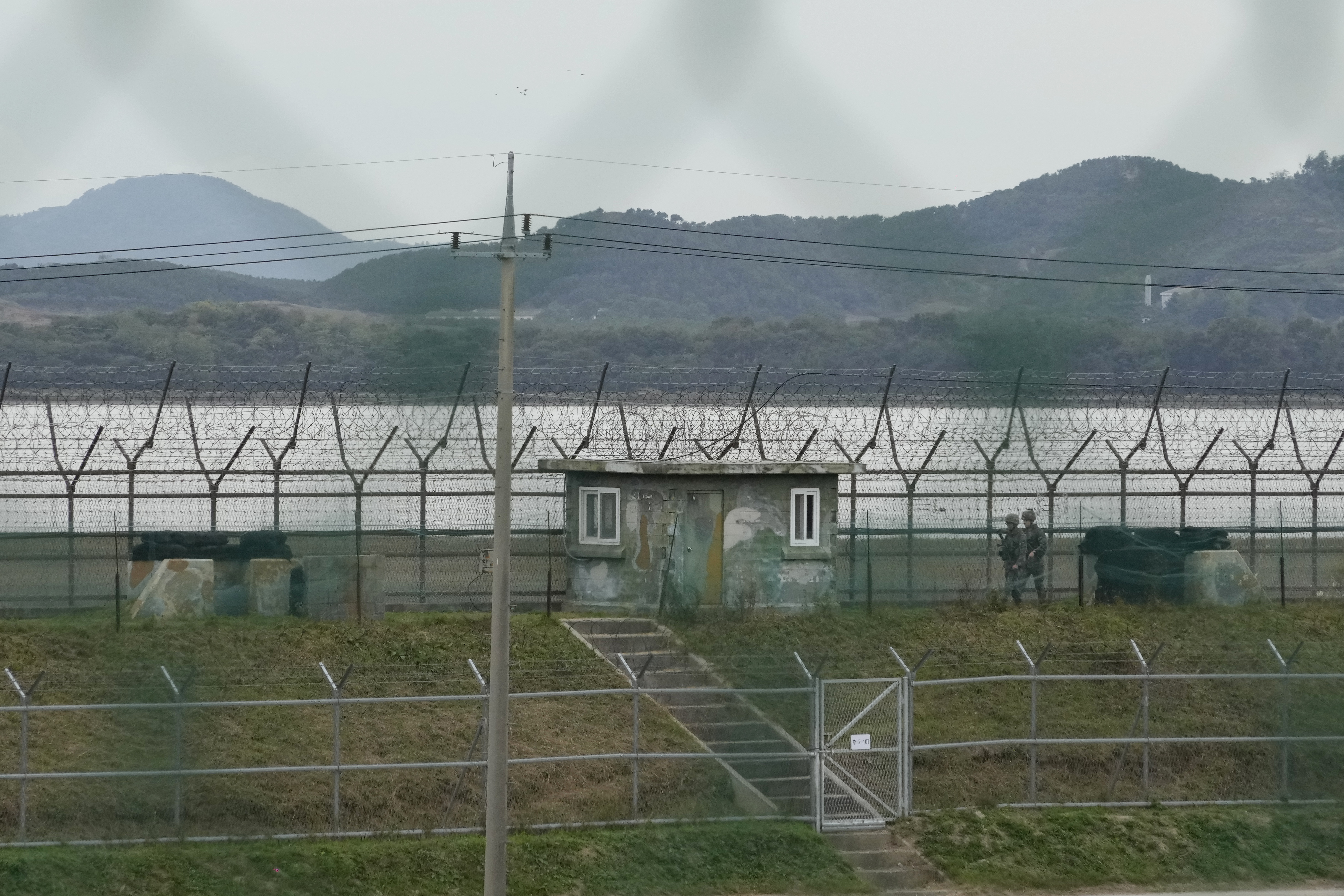 South Korean army soldiers patrol along the barbed-wire fence in Paju, South Korea, near the border with North Korea, Monday, Oct. 14, 2024. (AP Photo/Ahn Young-joon)