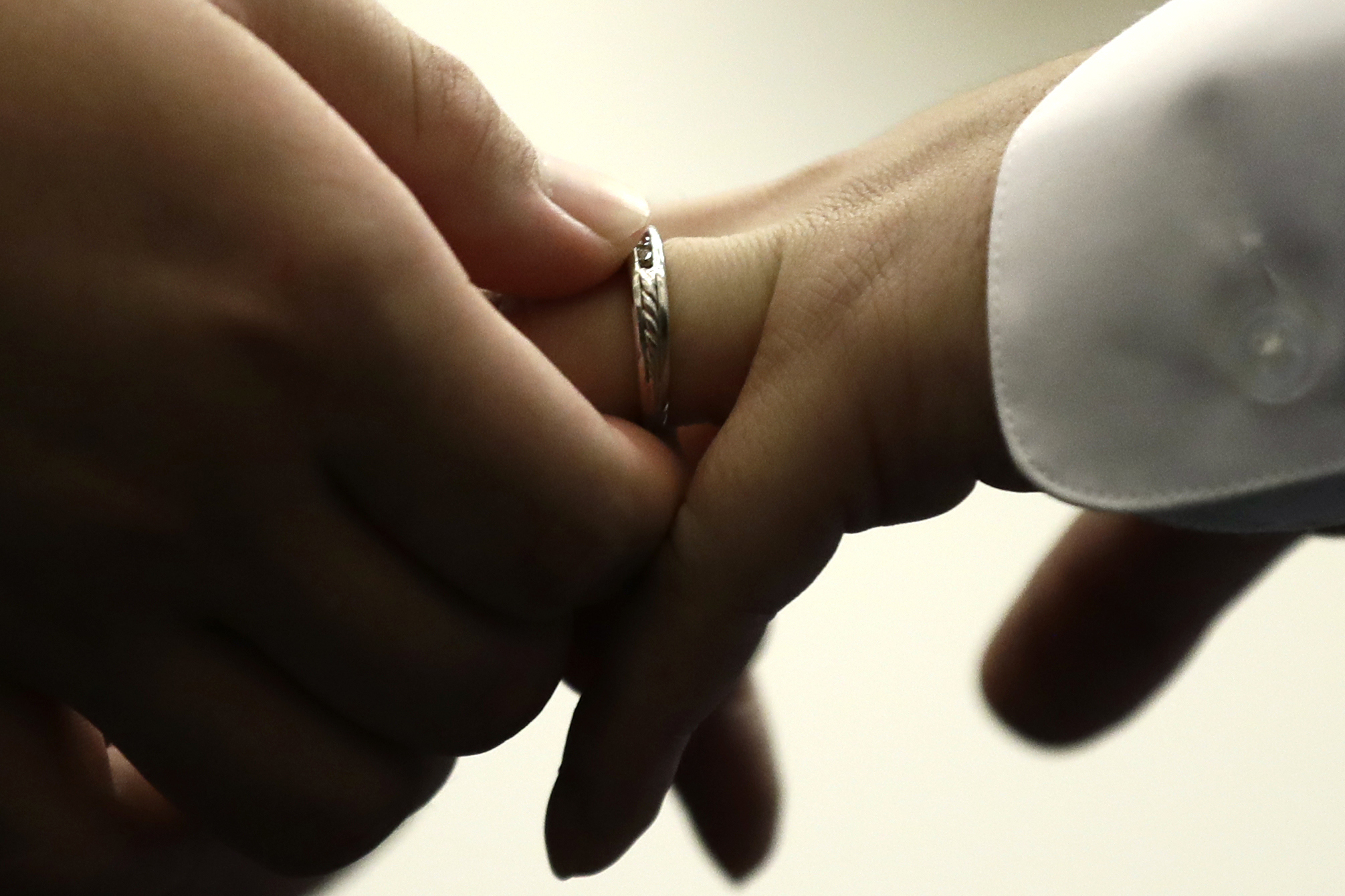 FILE - A couple exchanges wedding bands at City Hall in Philadelphia on Oct. 11, 2018. (AP Photo/Matt Rourke, File)