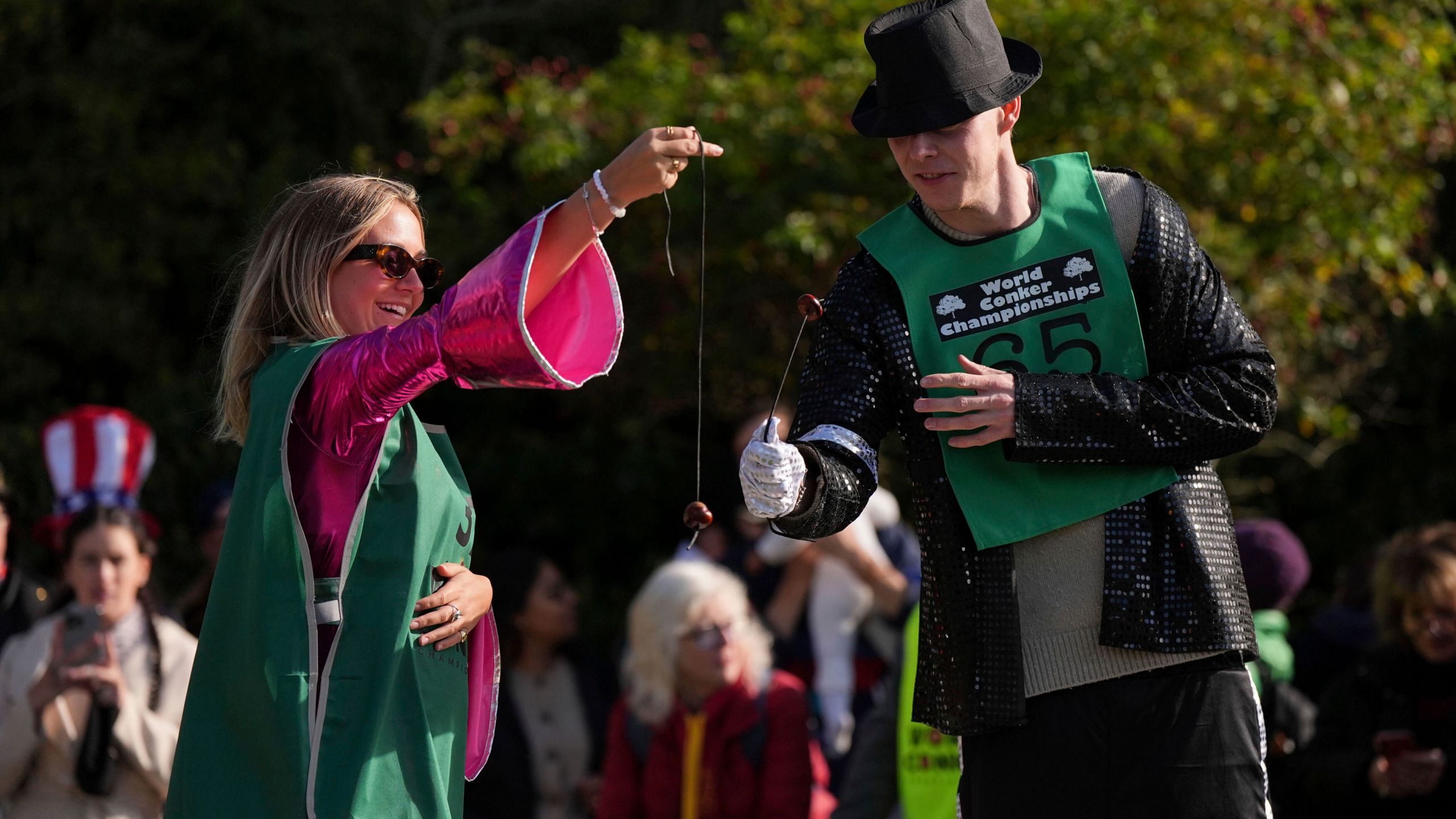 Competitors take part in the annual World Conker Championships at the Shuckburgh Arms in Southwick, Peterborough, England, Sunday Oct. 13, 2024. (Jacob King/PA via AP)