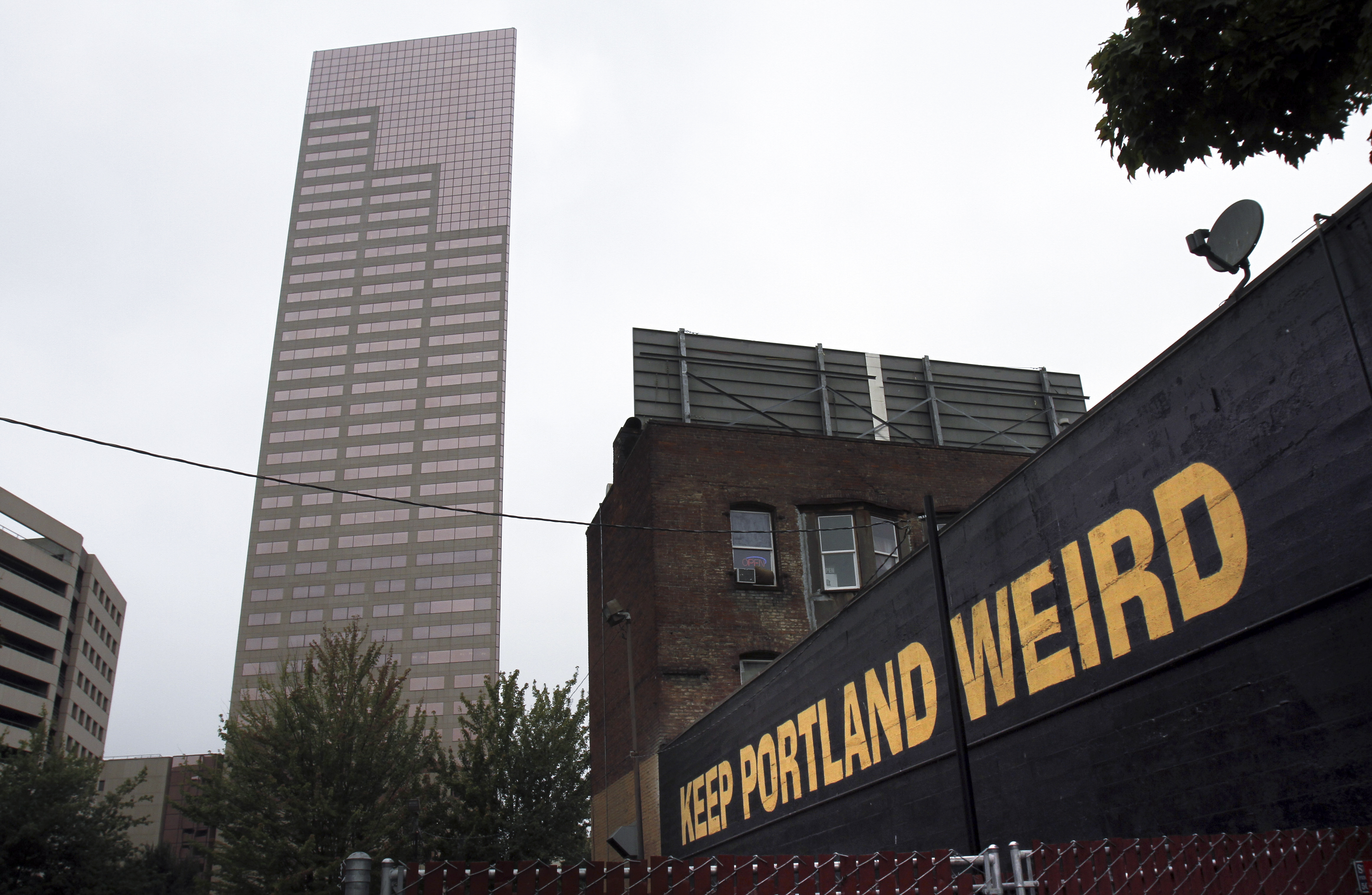 FILE - A downtown building displays a popular slogan in relation to the city in Portland, Ore., Sept. 19, 2012. (AP Photo/Don Ryan, File)