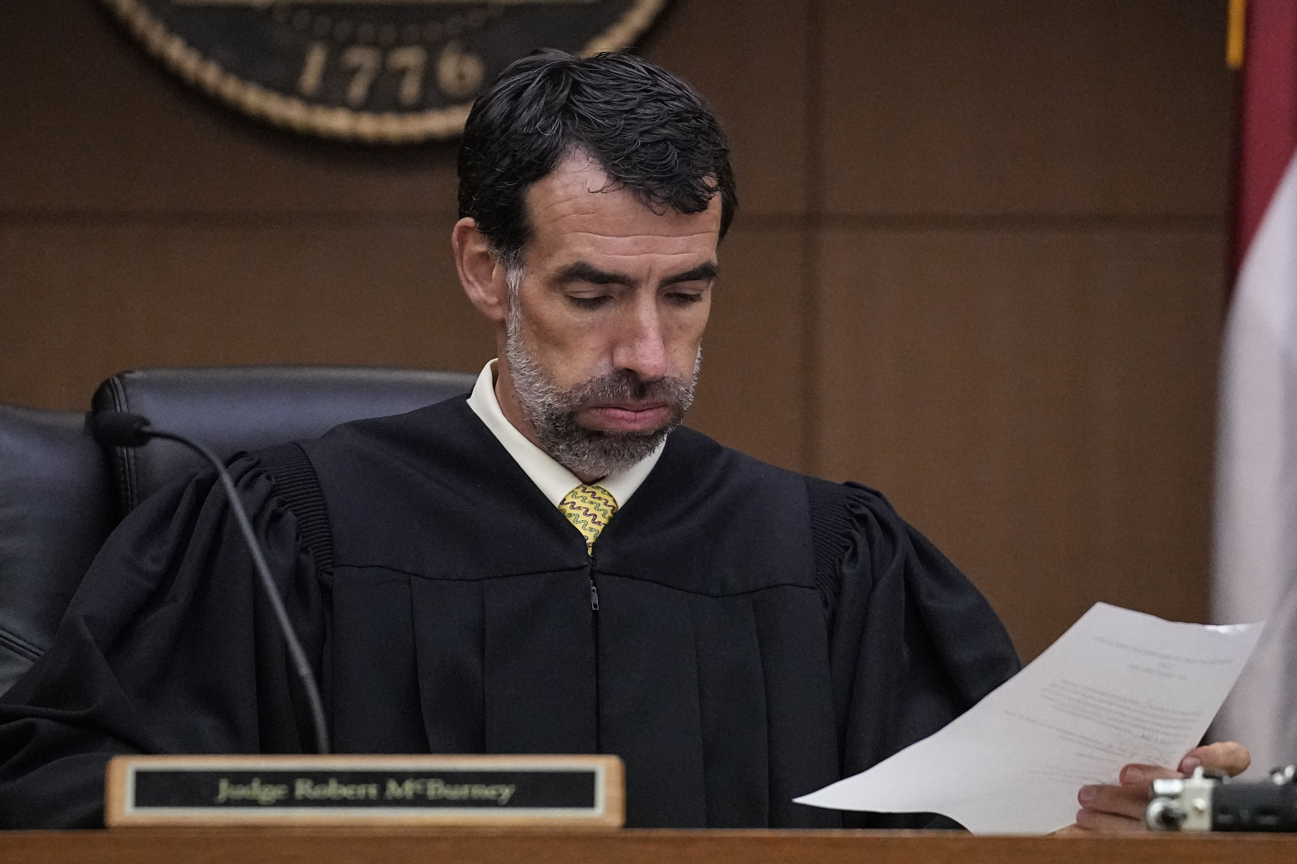 FILE - Fulton County Superior Court Judge Robert McBurney looks through paperwork, Monday, Aug. 14, 2023, in Atlanta. (AP Photo/Brynn Anderson, File)