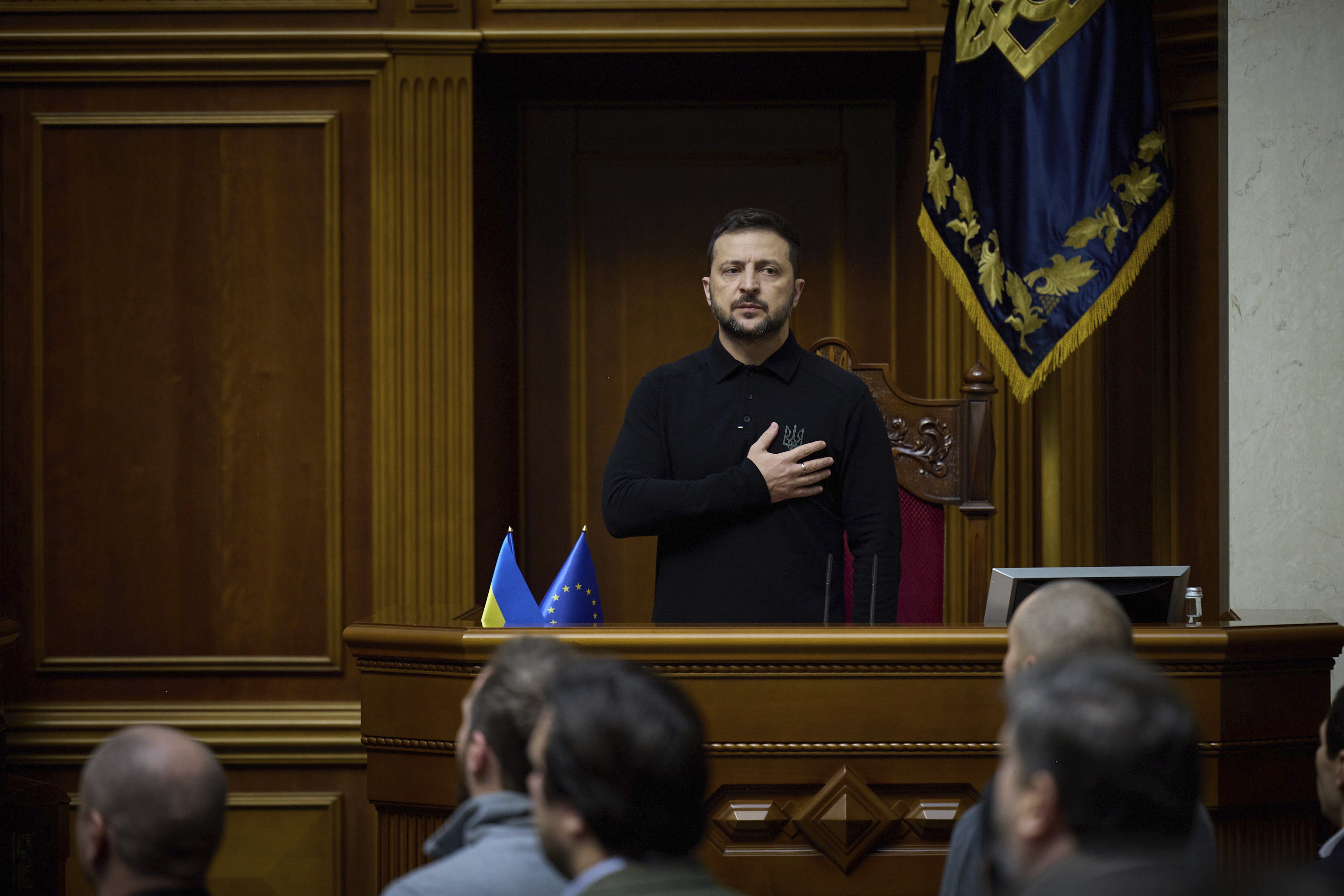 In this photo provided by the Press Service Of The President Of Ukraine on Oct. 16, 2024, Ukraine's President Volodymyr Zelenskyy listens to the national anthem before his speech at Verkhovna Rada in Kyiv, Ukraine. (Press Service Of The President Of Ukraine via AP)