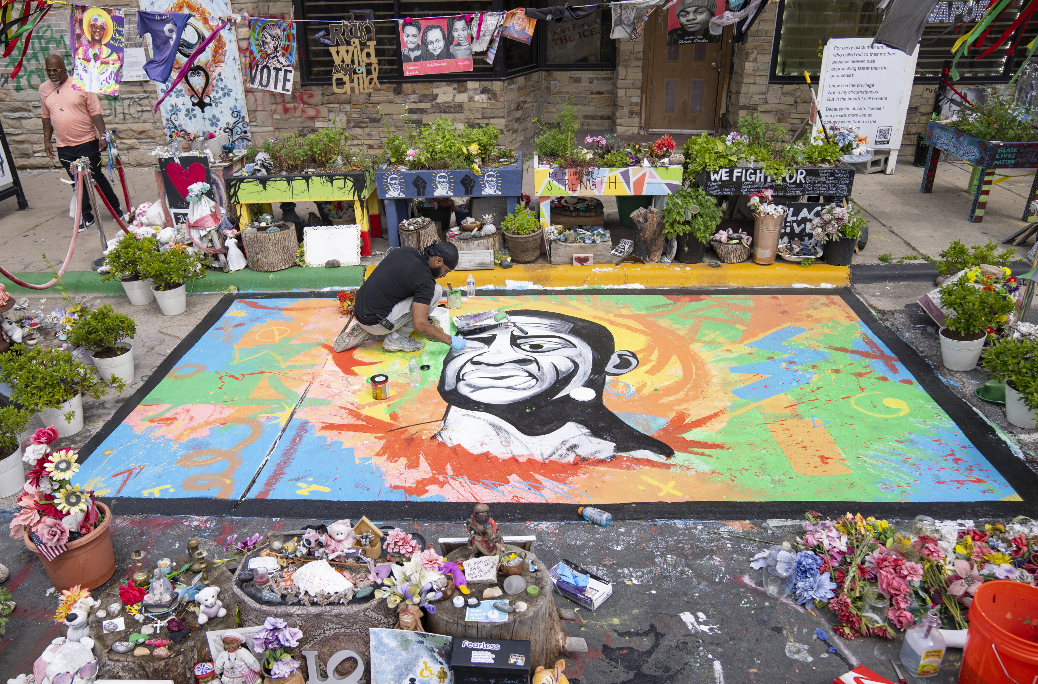 FILE - Antonio Jenkins paints a mural of George Floyd at the site where he was murdered by a police officer in 2020 at George Floyd Square in Minneapolis, May 25, 2024. (Alex Kormann/Star Tribune via AP, File)