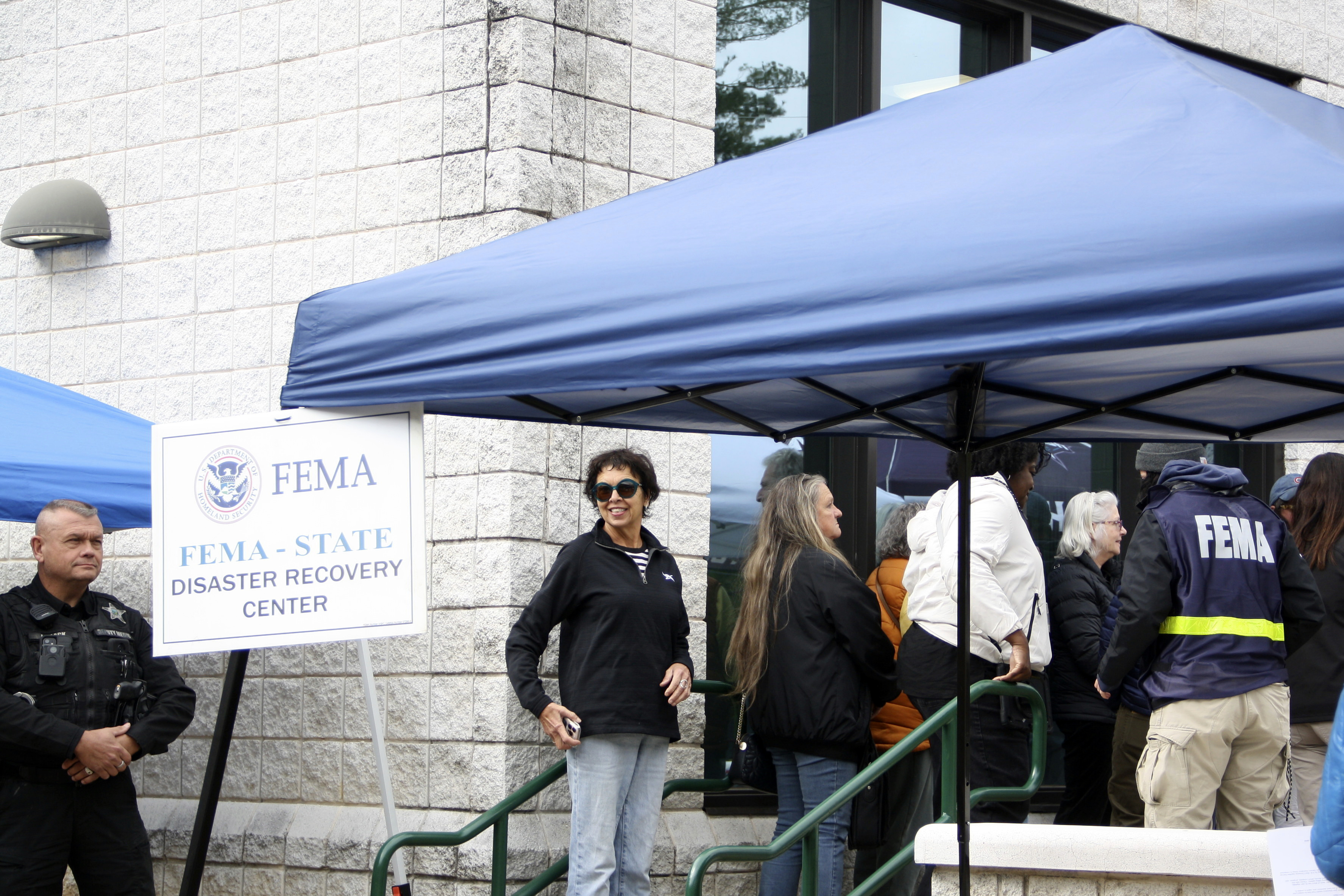 People gather at a FEMA Disaster Recovery Center at A.C. Reynolds High School in Asheville, N.C.,, Tuesday, Oct. 15, 2024. (AP Photo/Makiya Seminera)