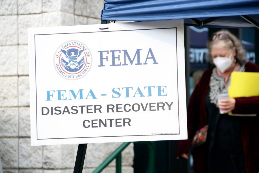 People gather at a FEMA Disaster Recovery Center at A.C. Reynolds High School in Asheville, N.C.,, Tuesday, Oct. 15, 2024. (AP Photo/Makiya Seminera)