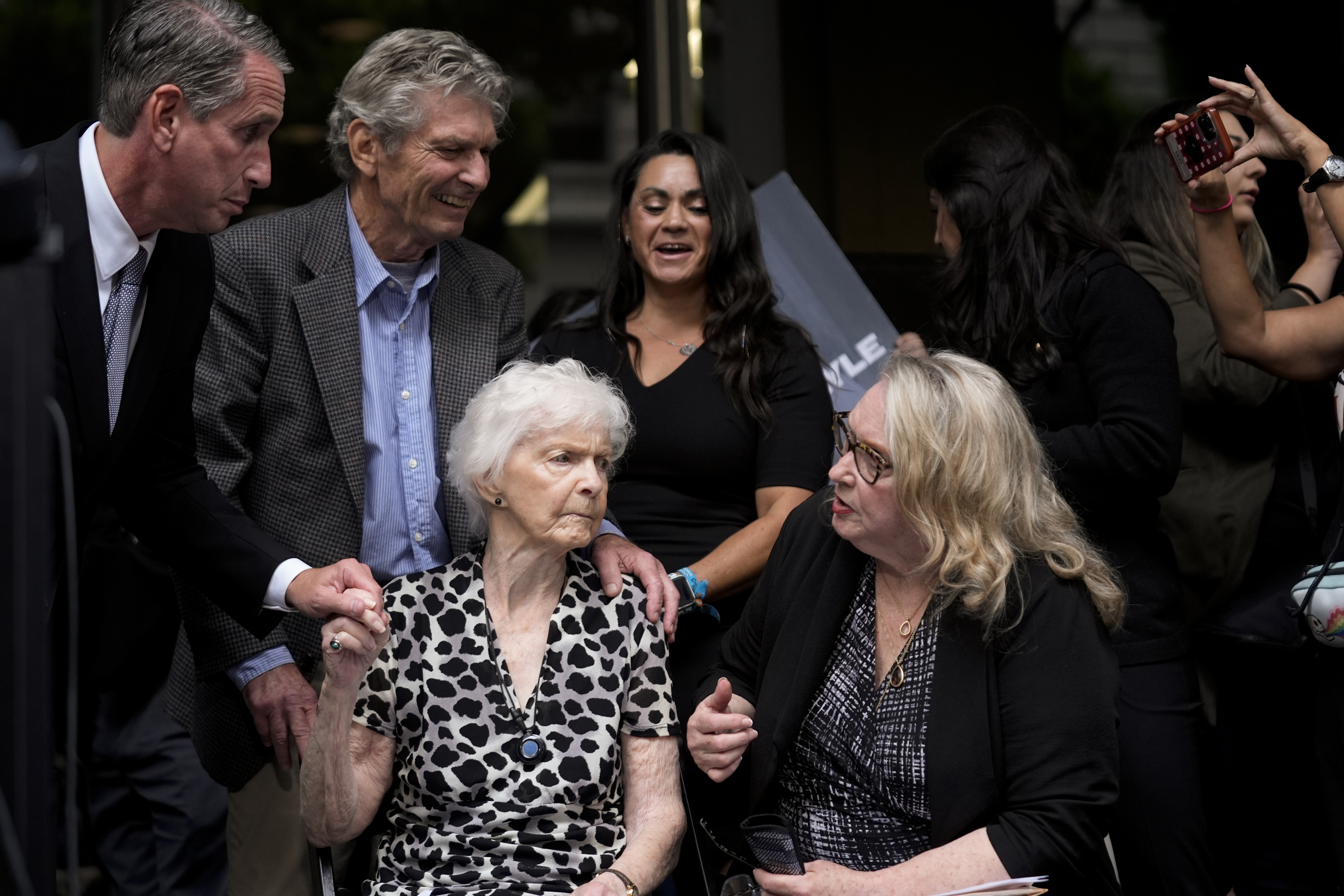 Kitty Menendez' sister, Joan Andersen VanderMolen, bottom left, and niece Karen VanderMolen, right, sit together during a press conference to announce developments on the case of brothers Erik and Lyle Menendez, Wednesday, Oct. 16, 2024, in Los Angeles. (AP Photo/Damian Dovarganes)