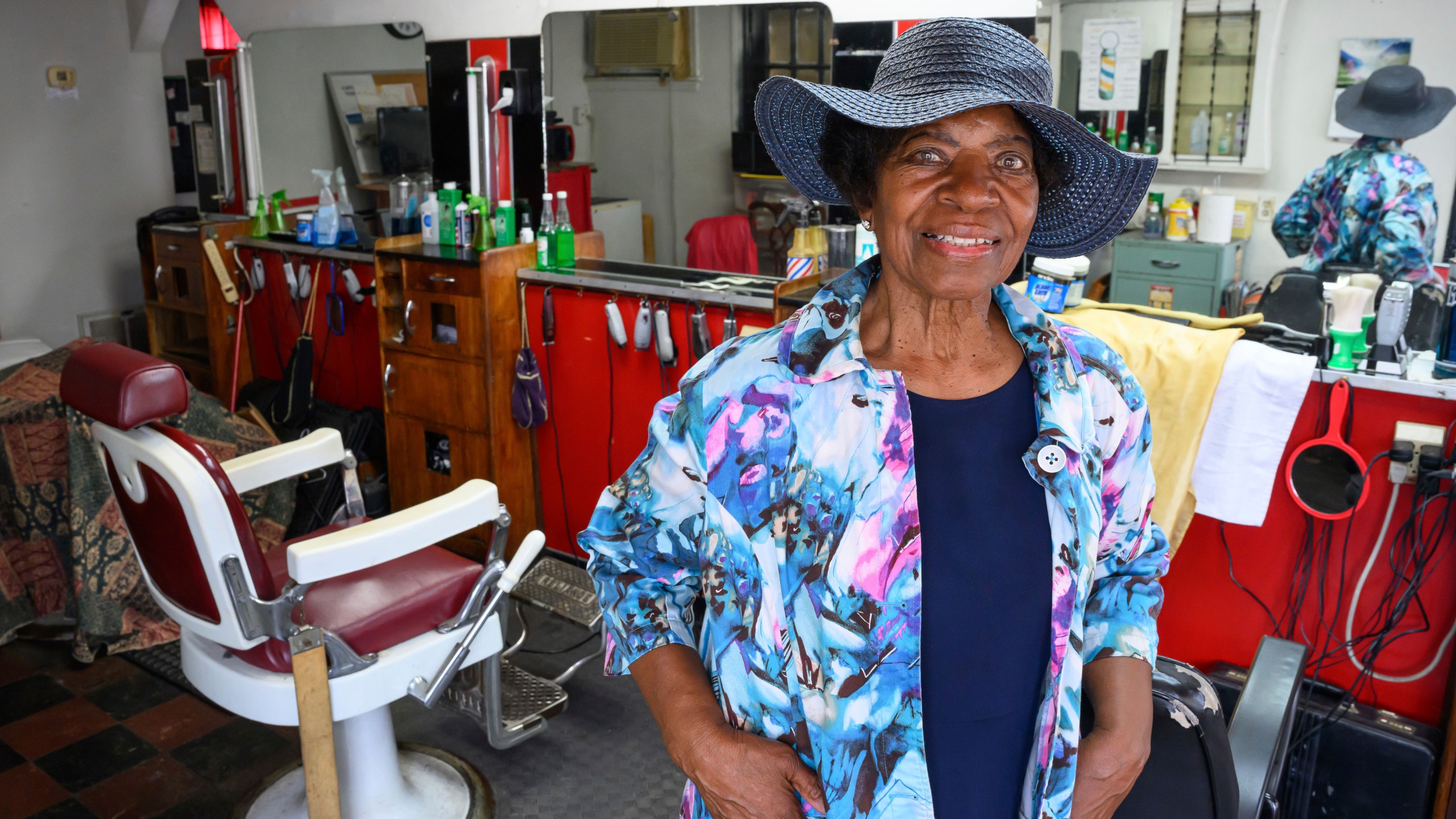 Courtney Speed, of Turner Station, Md., stands in Speed's Barber and Beauty, her salon, Sunday, Aug. 18, 2024, in Turner Station. Turner Station is located near the former site of the Francis Scott Key Bridge, which collapsed in March. (AP Photo/Steve Ruark)