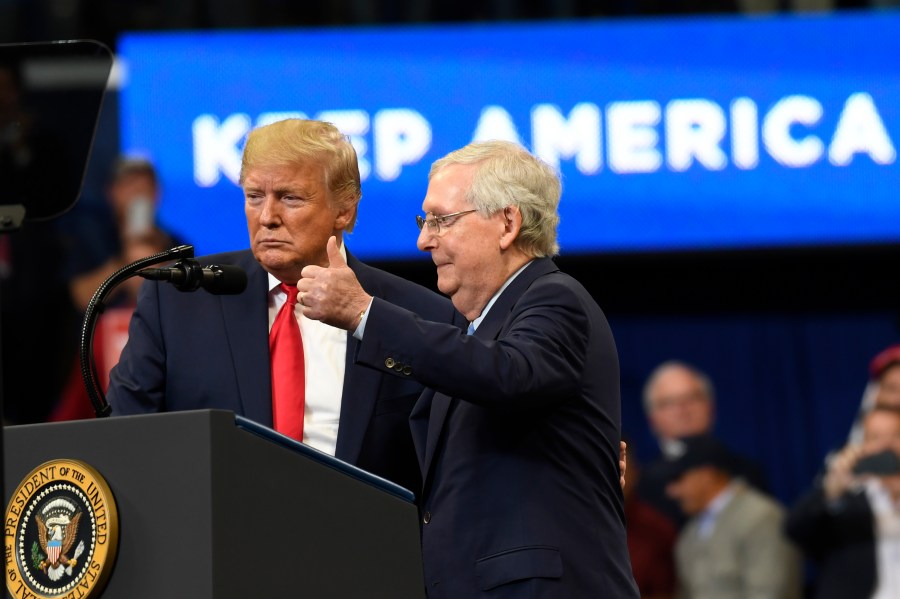 FILE - President Donald Trump brings Senate Majority Leader Mitch McConnell of Ky., on stage during a campaign rally in Lexington, Ky., Nov. 4, 2019. (AP Photo/Susan Walsh, File)