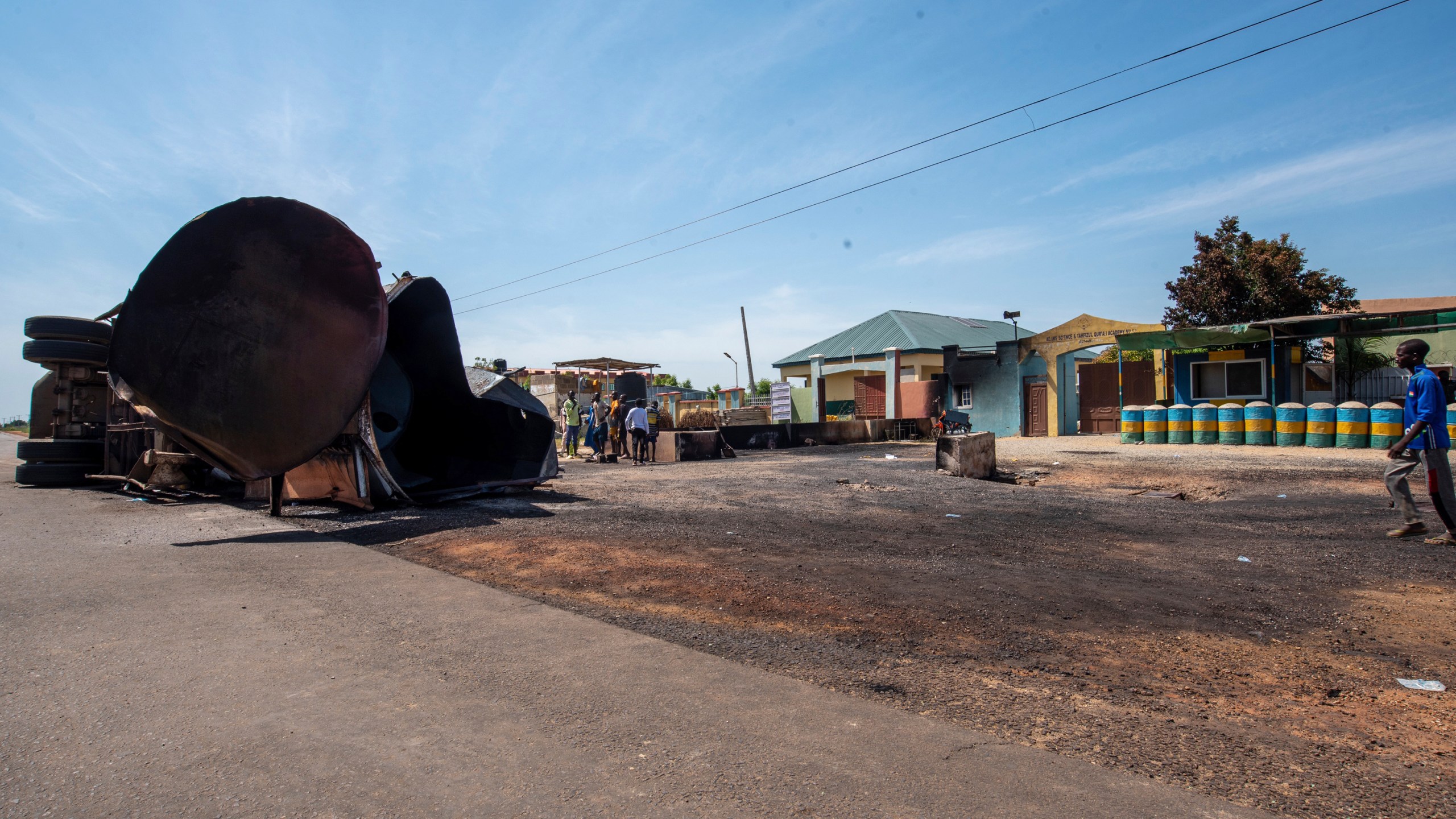 People gather at the scene of a fuel tanker explosion in Majiya town, Nigeria, Wednesday, Oct. 16, 2024. (AP Photo/Sani Maikatanga)