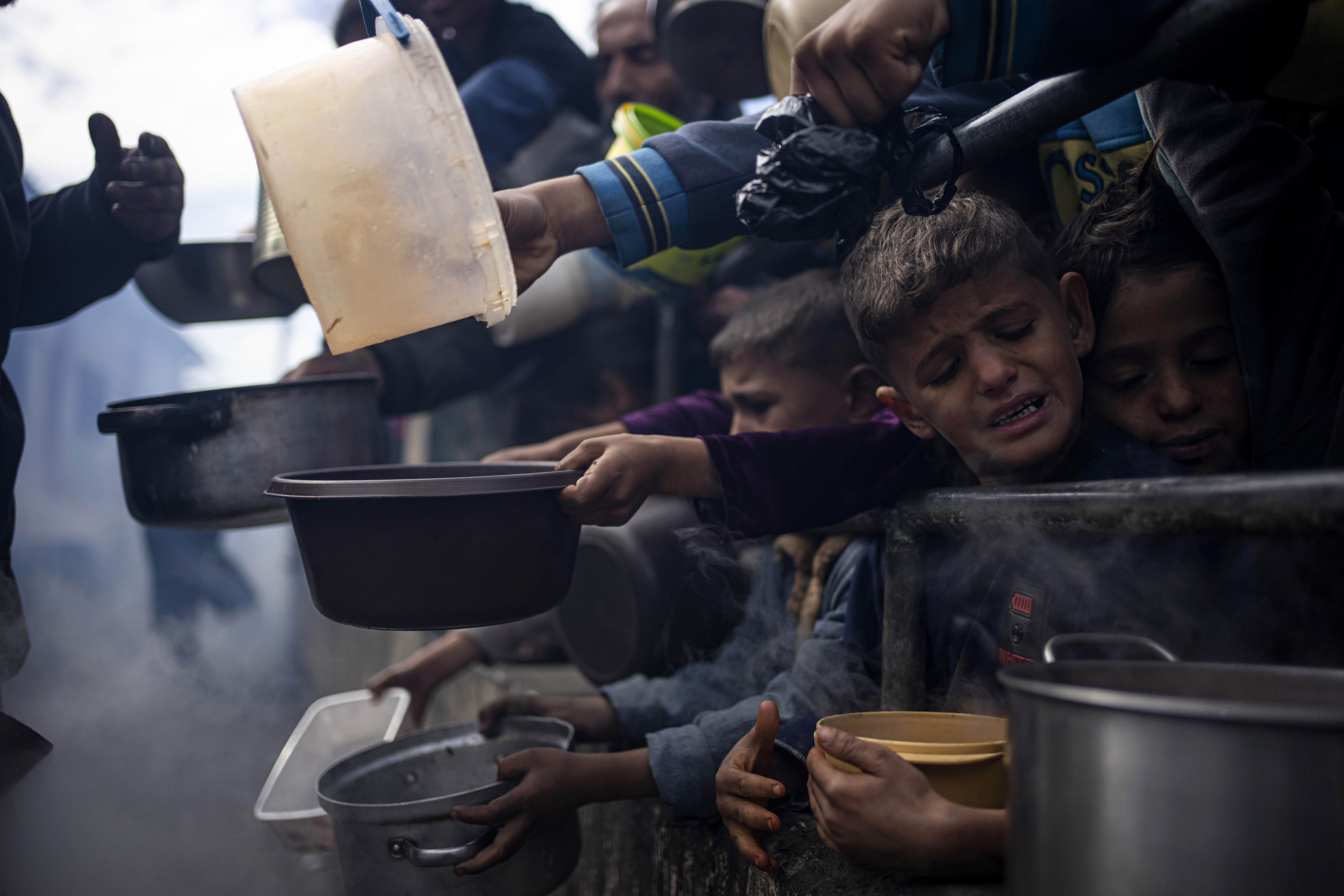 FILE - Palestinians line up for a meal in Rafah, Gaza Strip, Friday, Feb. 16, 2024. (AP Photo/Fatima Shbair, File)