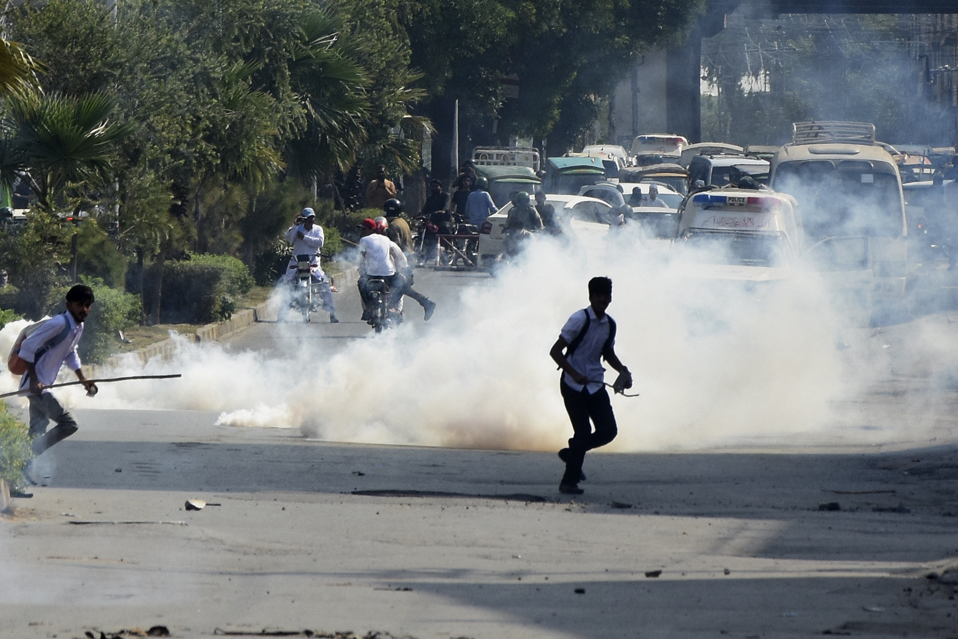 Police fire tear gas to disperse students protesting over an alleged on-campus rape in Punjab, in Rawalpindi, Pakistan, Thursday, Oct. 17, 2024. (AP Photo/W.K. Yousafzai)