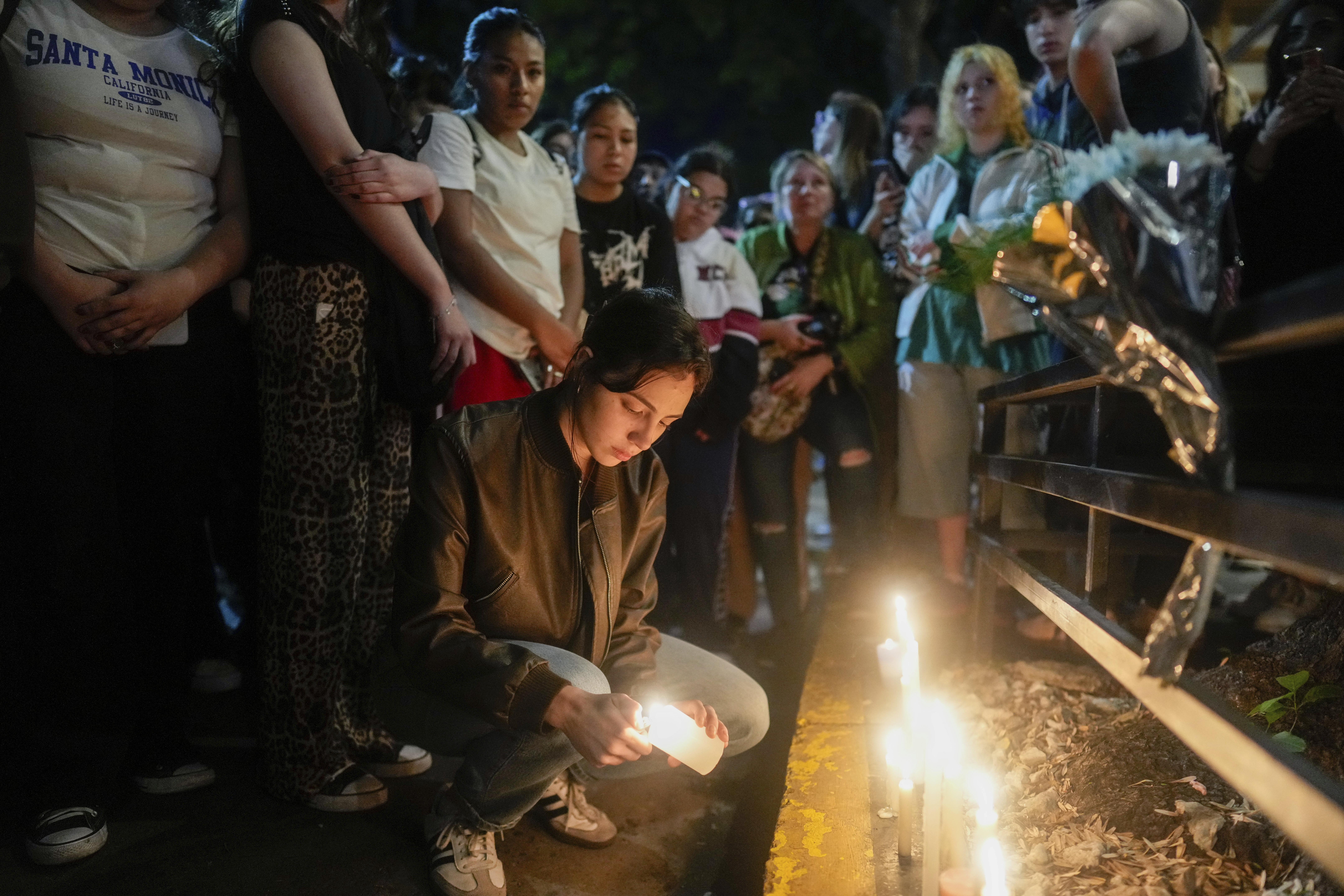 Fans light candles outside the hotel where former One Direction singer Liam Payne was found dead after he fell from a balcony in Buenos Aires, Argentina, Wednesday, Oct. 16, 2024. (AP Photo/Natacha Pisarenko)