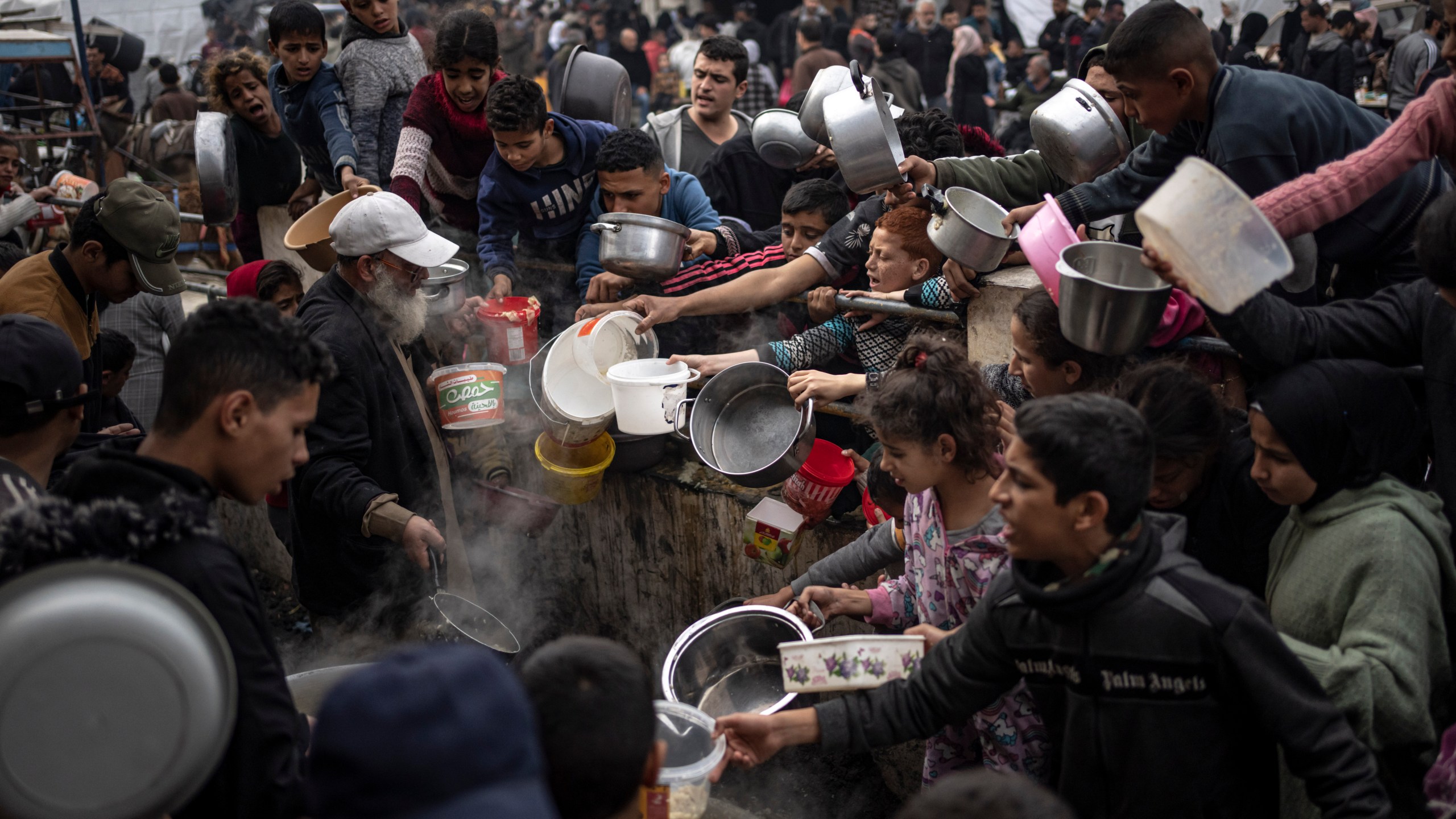 FILE - Palestinians line up for a meal in Rafah, Gaza Strip, on Dec. 21, 2023. (AP Photo/Fatima Shbair, File)