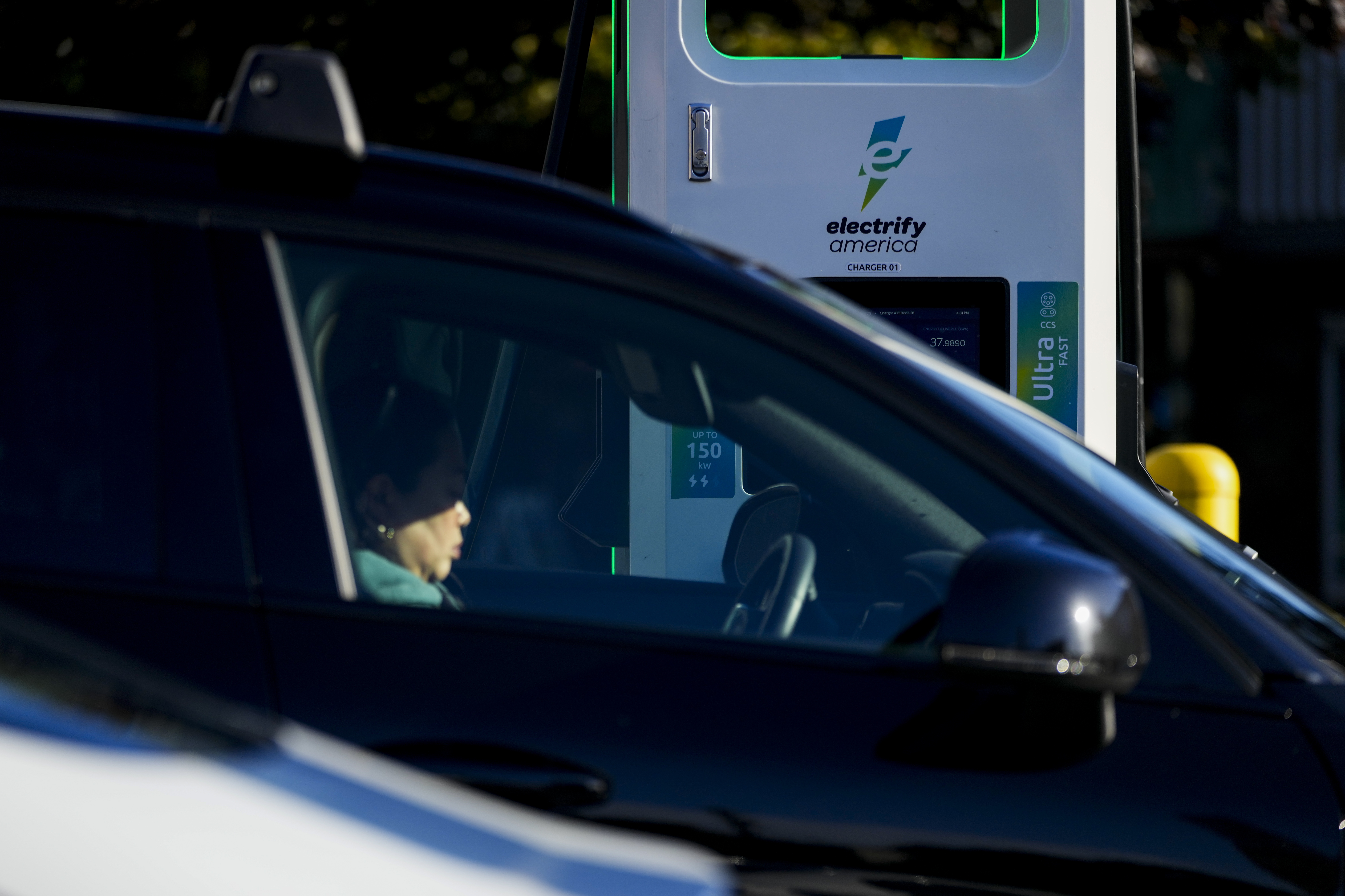 FILE - A driver waits in their car while charging their electric vehicles at an Electrify America station, Oct. 9, 2024, in Seattle. (AP Photo/Lindsey Wasson, File)