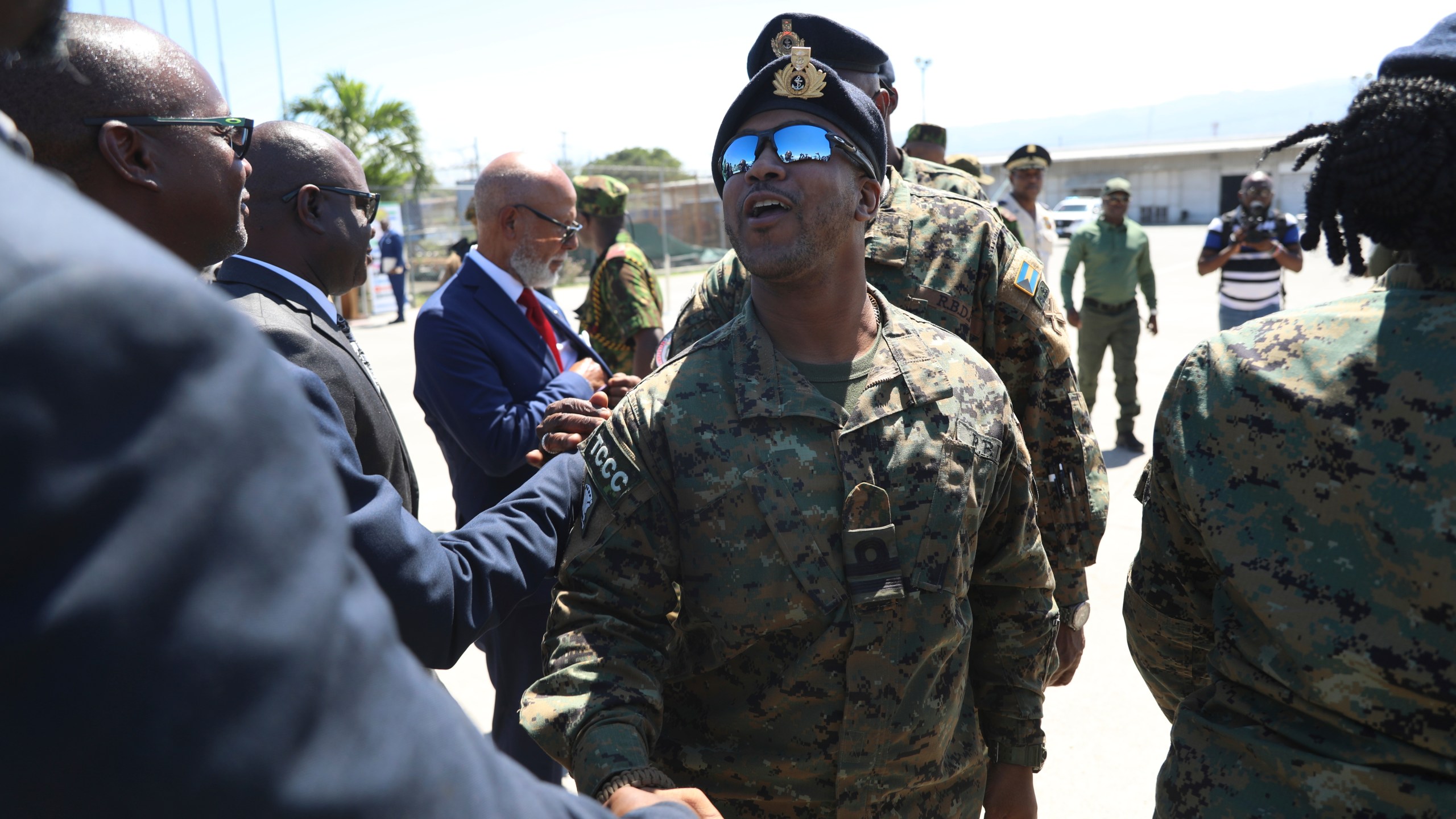 Police from the Bahamas are welcomed by Haitian and Kenyan police, part of a UN-backed multinational force, at the Toussaint Louverture International Airport in Port-au-Prince, Haiti, Friday, Oct. 18, 2024. (AP Photo/Odelyn Joseph)