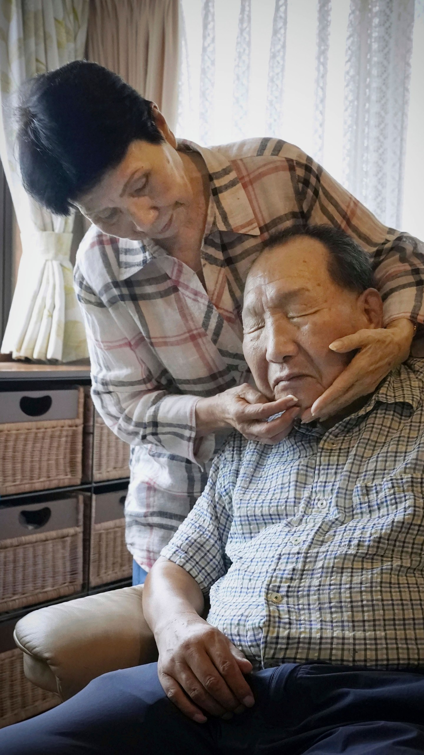 Hideko Hakamada, left, sister of former boxer Iwao Hakamada who has been on death row for a 1966 quadruple murder case, puts moisturizer on her brother's face after shaving, in Hamamatsu, Shizuoka prefecture, central Japan, on Aug. 20, 2021. Japanese prosecutors said on Oct. 8, 2024 they will not appeal the Sept. 26 ruling of the Shizuoka District Court that acquitted the world’s longest-serving death-row inmate in a retrial. (Kyodo News via AP)