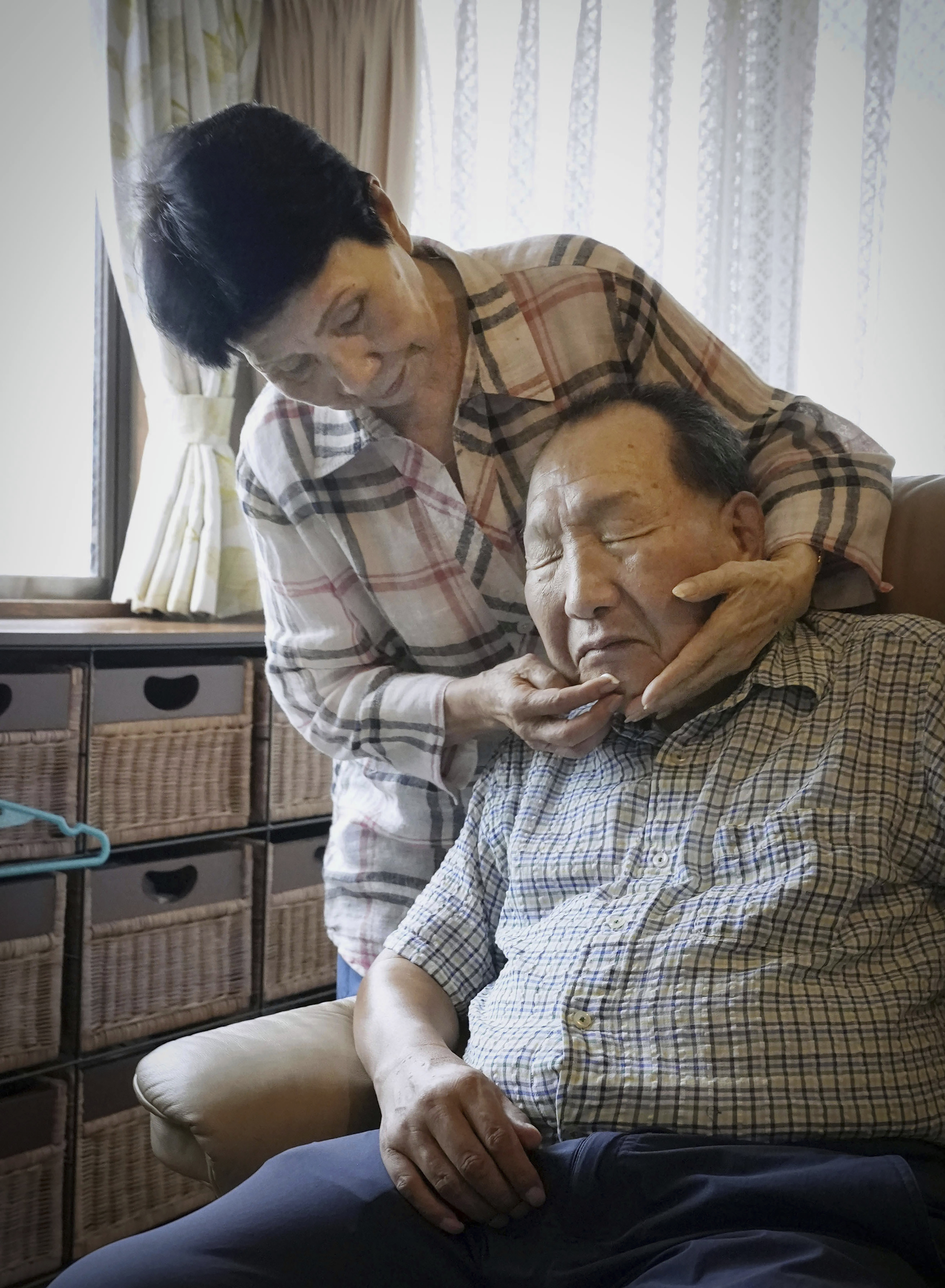 Hideko Hakamada, left, sister of former boxer Iwao Hakamada who has been on death row for a 1966 quadruple murder case, puts moisturizer on her brother's face after shaving, in Hamamatsu, Shizuoka prefecture, central Japan, on Aug. 20, 2021. Japanese prosecutors said on Oct. 8, 2024 they will not appeal the Sept. 26 ruling of the Shizuoka District Court that acquitted the world’s longest-serving death-row inmate in a retrial. (Kyodo News via AP)