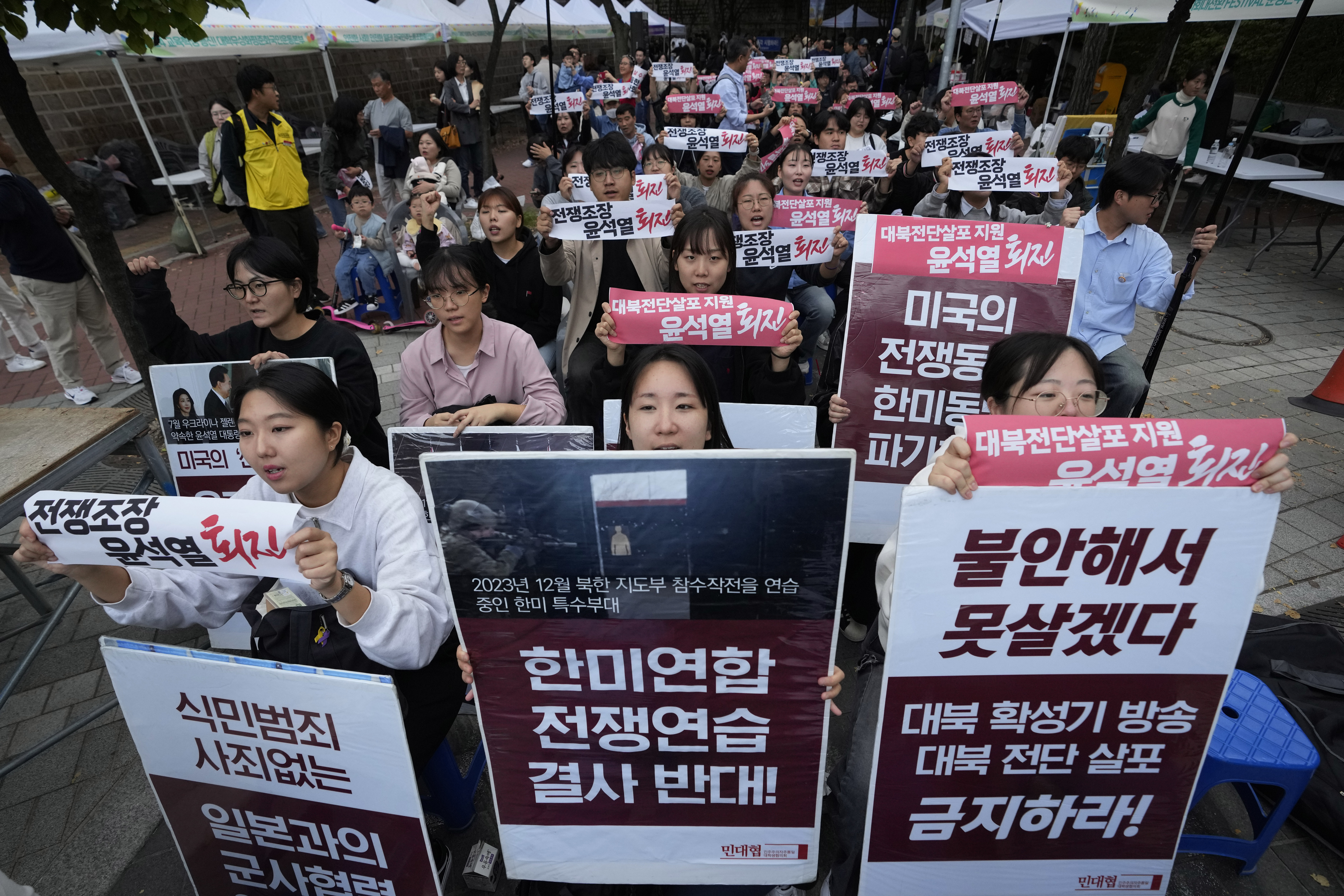 South Korean protesters stage a rally against flying of anti-North Korean propaganda leaflets into North Korea, in Seoul, South Korea, Saturday, Oct. 19, 2024. The banners read, "Opposition to South Korea-U.S. joint war exercise." (AP Photo/Ahn Young-joon)