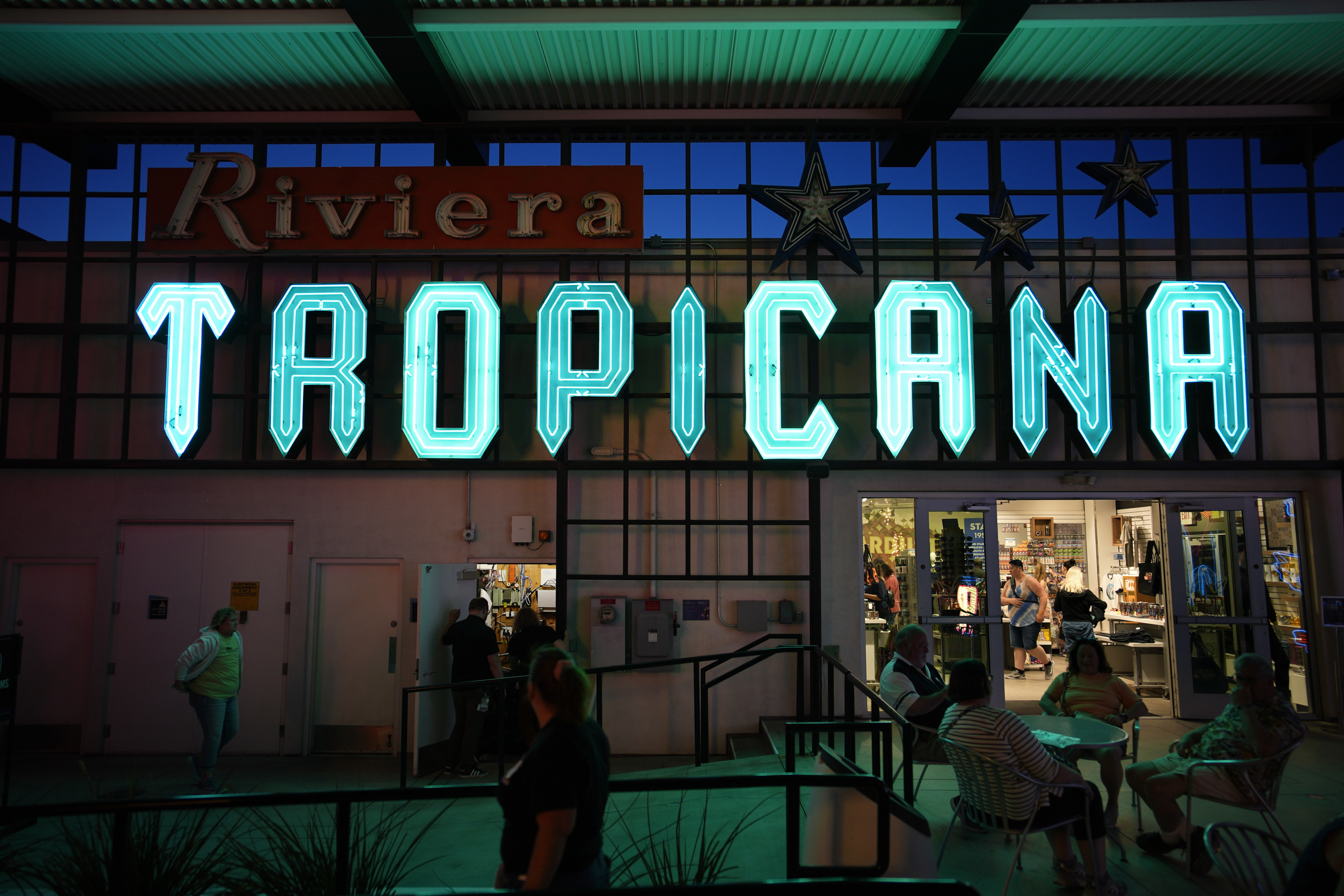 People walk by a sign for the Tropicana on display at the Neon Museum, Wednesday, April 3, 2024, in Las Vegas. (AP Photo/John Locher)